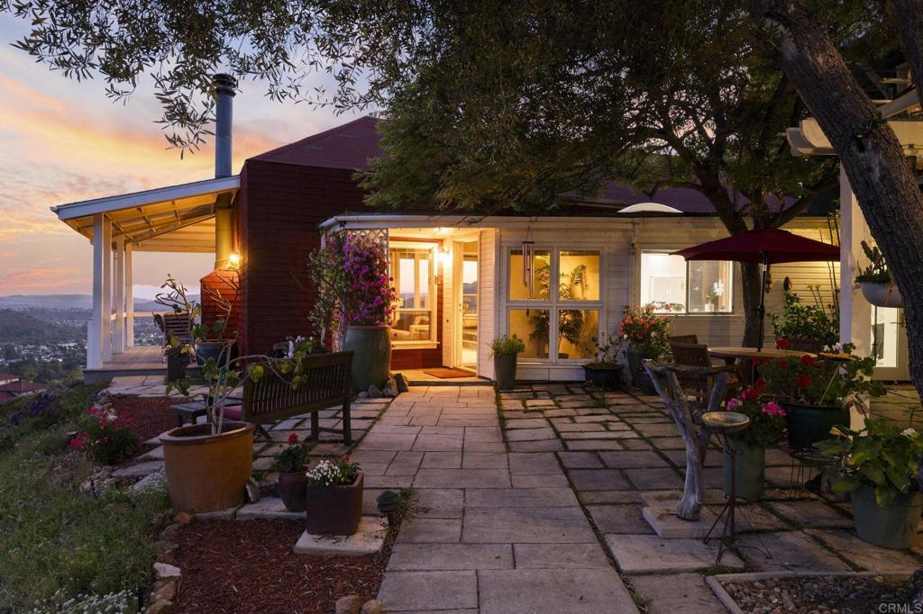 Set on over 2 acres in Poway’s coveted High Valley neighborhood, this property is designed for outdoor living and entertainment, with multiple spaces—including a wraparound porch, stone courtyard, and private backyard—perfect for enjoying panoramic west-facing views that stretch to the Pacific Ocean. Inside, vaulted ceilings, abundant natural light, and an open layout create seamless indoor-outdoor flow throughout the 3BR/2.5BA home, which also features a dedicated office (optional 4th bedroom) and a detached studio with water and electricity—ideal for creative use or potential ADU conversion. The spacious primary suite offers a soaking tub, dual vanities, and a 15-foot walk-in closet, while owned solar with a Tesla Powerwall and a three-car garage add modern efficiency and convenience. With potential for a lot split to build a second home and close proximity to shopping, dining, and top-rated schools, this rare High Valley opportunity captures the best of Poway living.