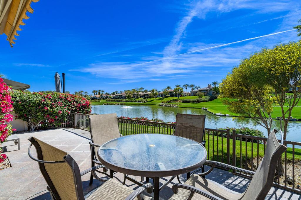 Updated with South Lake Views! CLUB Membership available for this home. Offered Turnkey Furnished, this Acacia 4 model condo features 3 bedrooms/3.5 bathrooms in the private, guard-gated Indian Ridge Country Club. The south-facing fairway patio is fenced with electric awning and pavers, and provides expansive views of lake, mountains and Grove #7. Open floor plan with views and direct access to patio area from living room and kitchen - ideal for dining & entertaining. Living room features a fireplace, electric window blinds and wet bar. The separate dining area is open to the living room and adjacent to the kitchen. Light and bright with tile and laminate flooring throughout. New furnace, NEST thermostats & Ring doorbell. Kitchen has been updated with electric blinds, granite counters, stainless appliances, oven with a warming drawer and large island. The cozy breakfast nook looks out to the patio with the lake beyond. The Primary suite has a private patio and remodeled ensuite bathroom with raised granite counters, a free-standing tub, a separate shower and a large walk in closet. Both of the guest bedrooms are en suite, with the front bedroom currently set up as a den with office workspace. The attached 2-car garage has direct access in to the house via the laundry room. Great location - just two houses away from one of the many community pools & spas, and around the corner from ''Rover's Ridge'' dog park. HOA monthly dues include security, cable & internet, all gardening, exterior paint, roof maintenance, exterior water, exterior pest control and trash. Come Join the Fun!
