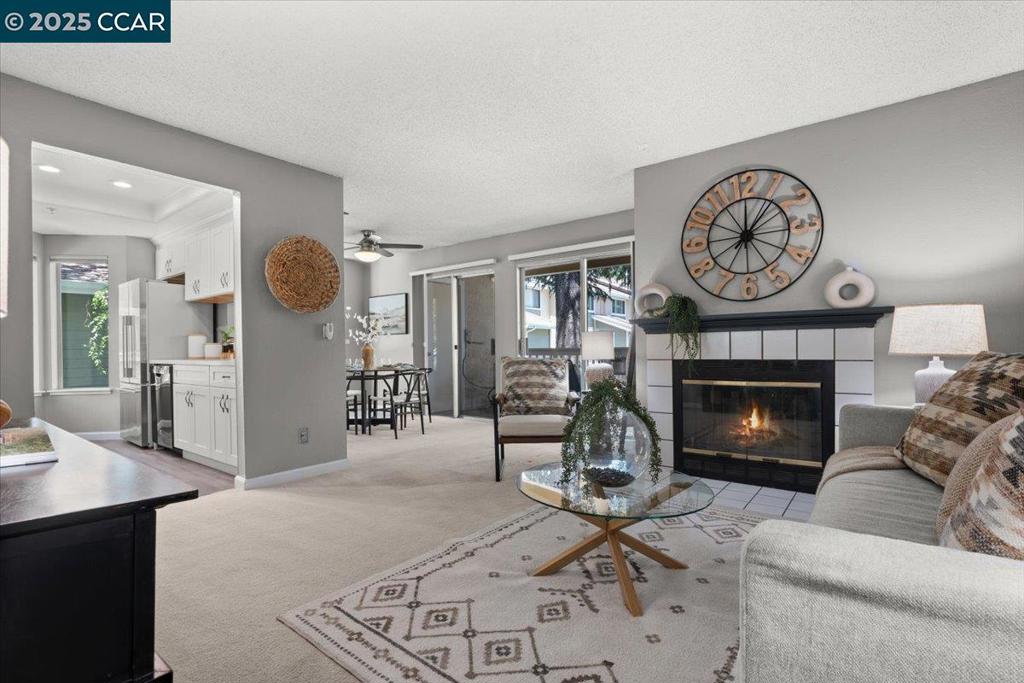 Welcome to this beautifully updated 2-bedroom, 1-bath condo in the desirable Carriage Place community. Thoughtfully updated, this home offers a perfect balance of comfort, style, and convenience. The remodeled kitchen features quartz countertops, white shaker cabinets, recessed lighting and opens to the dining and living areas—great for entertaining or relaxing at home. Step out onto the shady private patio and enjoy peaceful views of surrounding redwood trees, creating a serene, park-like backdrop. The spacious primary suite includes a walk-in closet. Other highlights include in-unit laundry, central heat and air, and covered parking. Carriage Place offers a sparkling community pool, beautifully maintained, tree-lined grounds, and a tranquil atmosphere. Located just steps from Walden Park, Iron Horse Trail, Bay Club, and BART—with top-rated Walnut Creek schools and easy access to major commuter routes—this home is ideal for those who enjoy an active, connected lifestyle close to nature, dining, and everyday amenities.
