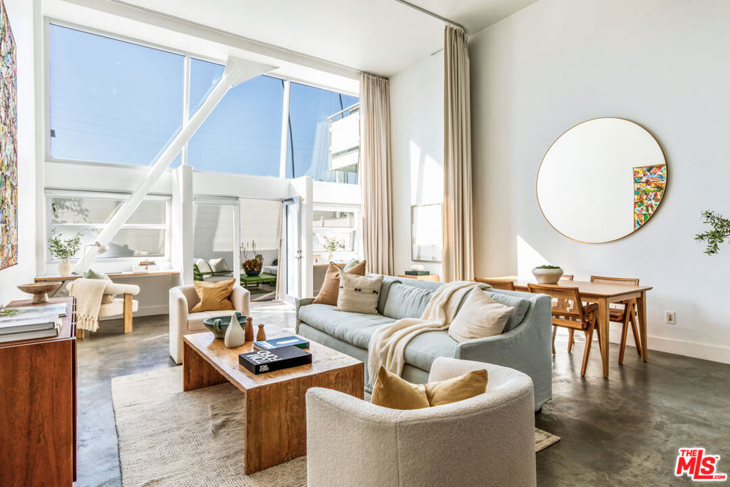 This undeniably Venice loft in the acclaimed Venice Art Lofts is calling your name! Experience the best of Venice living in this striking 1-bedroom, 2-bathroom two-story loft spanning 1,451 square feet. Designed with a modern industrial aesthetic, this residence features soaring two-story ceilings, sleek concrete floors, and a thoughtfully renovated kitchen that seamlessly blends form and function. The expansive open-concept living area flows onto a private patio ideal for indoor-outdoor living and entertaining. Central air conditioning and heat provide year-round comfort, while architectural lines and abundant natural light create a sophisticated ambiance. Tucked in a vibrant Venice location just moments from the beach, Rose Avenue, Abbot Kinney Boulevard, and acclaimed local favorites such as Gjusta, Wabi on Rose, and Fig Tree. Enjoy unparalleled access to the best dining, shopping, and coastal experiences that Westside LA has to offer. The unit has two assigned parking spaces in a secure subterranean garage. This is urban coastal living at its most inspired, modern, effortless and the perfect place to call home.