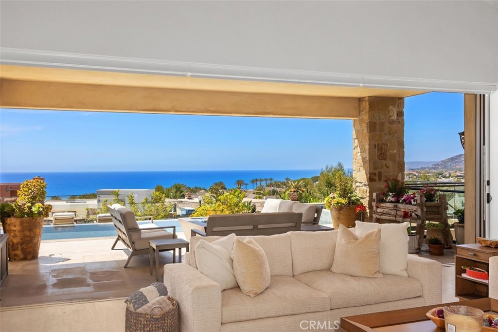 Escape to your own true resort-caliber estate in this elegantly timeless villa, exquisitely crafted in the Mediterranean style and offered **fully furnished** in California's most exclusive guard-gated oceanfront community, The Strand at Headlands. Breathtaking ocean views abound throughout this private retreat, which is graced with bespoke amenities such as an ocean-view salt water infinity pool and spa, stone loggia, sprawling entertaining terrace with outdoor fireplace, fitness/massage room with dry sauna and steam, huge game room with custom billiards table and an 18' full bar, walk-in wine cellar/tasting room, home theater room, outdoor cooking area, and privately gated front courtyard. The property underwent a complete restoration in 2024. The sweeping great room opens the kitchen to formal dining and sitting areas, and features stone floors, colonnades, and barrel-vaulted and beamed ceilings. The kitchen is well-appointed, with multiple sinks, dishwashers and refrigerators, double oven, an oversized stone island bar, a butler's pantry, secondary dining area and ample storage cabinets. The primary suite features 2 view balconies, separate lounge/office, lavish double bathroom, 2 walk-in closets, tray ceiling, and fireplace. All of this is orchestrated on a grand scale encompassing 5 bedrooms and 8.5 baths – over 9,000 square feet – with 4 garage spaces, 5 fireplaces, 4 balconies, multiple water features, and gardens spanning an oversized lot. Very high ceilings and slide-away glass doors invite natural light throughout the day. Discerning visitors will appreciate the meticulous craftsmanship of this fine home, with custom furniture curated for every indoor and outdoor space. All furnishings are new and were installed by Andrea Bruley Designs or sourced directly by owner.
The renowned Strand at Headlands community, one of the most affluent gated neighborhoods in the world, offers an oceanfront clubhouse and pool, private beach lockers, walking and biking trails, and golf-cart parking behind private gates. It is in very close proximity to Dana Point's recently renovated Lantern District, and also Dana Point Harbor, currently being revitalized to be one of the most vibrant marine districts on the west coast.