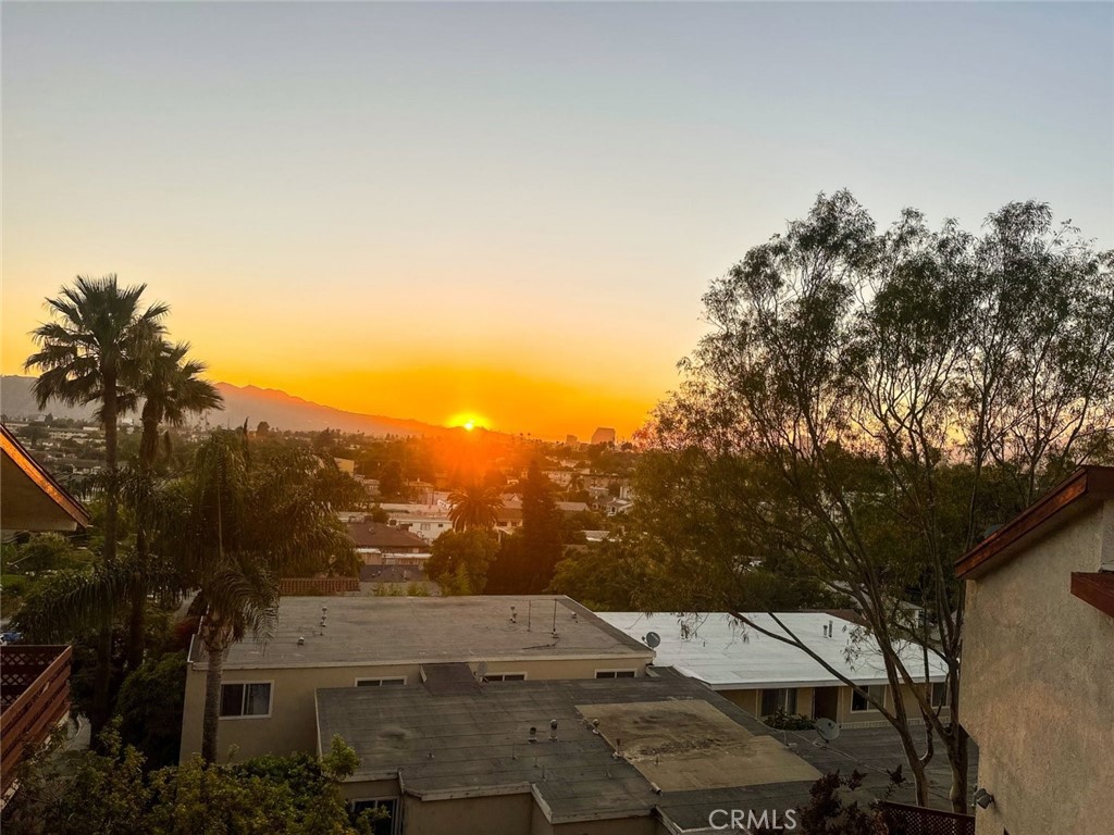 Nestled in one of Glendale’s most desirable neighborhoods, this stylish 2-bedroom, 1.5-bath condo combines comfort, convenience, and modern appeal. An inviting living space featuring soaring ceilings, wood-style floors, and abundant natural light. The kitchen, equipped with stainless steel appliances, granite countertops, and generous cabinetry, flows into the open living and dining areas—perfect for both everyday living and entertaining. Enjoy breathtaking sunset views of the mountains and downtown Glendale from your private patio. Downstairs, you’ll find two spacious bedrooms, including one with a balcony overlooking the city skyline. Ample closet space and sun-filled windows enhance each room. Updated half bath upstairs and one full bath downstairs. Additional highlights include: Prime location in Building A with easy access, downstairs bedrooms featuring a separate entrance for added flexibility, two assigned parking spaces, community laundry facilities, with HOA approval for in-unit washer/dryer installation, recently upgraded AC unit, windows, and sliding doors. Tucked within a tranquil cul-de-sac inside a gated community, this home offers peace and privacy while still being just minutes from shopping, dining, freeways, and more.