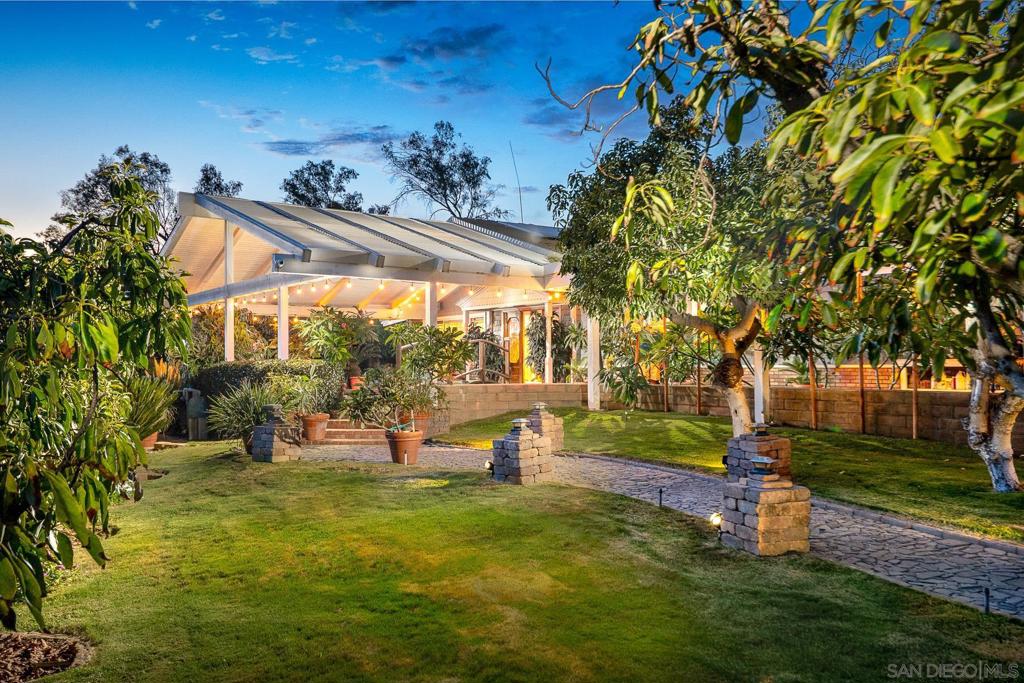 Step into a truly one-of-a-kind property where House, Guest House, Koi Ponds, Greenhouse, Solar, and so much more create a serene, tropical retreat. The main house, spanning 2,743 square feet, welcomes you with a stunning bridge over a large koi pond and a beautiful lava rock waterfall. Inside, skylights throughout provide year-round natural light. The home features an oversized, 600+ square-foot master suite with a cozy pot belly stove, perfect for a private escape. The entire property is powered by owned solar, making it an all-electric, eco-friendly home. Stroll down the path and discover a breathtaking landscape adorned with staghorn ferns and plumerias, giving it a lush, tropical feel. The grounds are an edible paradise with a variety of fruit trees, including peaches, pears, plums, papaya, and mango, to name a few. For the aspiring gardener, plumbing is already in place for future growth. The path leads you past seven waterfall ponds filled with koi and to a tranquil greenhouse with two small ponds and another lava rock waterfall. An oversized tool shed and chicken coop provide additional space for hobbies and self-sufficiency. The guest house, at 938 square feet, offers a private space for visitors. It includes two bedrooms, with the main bedroom upstairs opening to an outdoor deck perfect for watching the sunset. It also has its own pot belly stove for warm, cozy evenings. Attached is a spacious garage/shop with a carport, offering plenty of room for vehicles and projects. This property is a sanctuary where comfort and nature blend seamlessly.
