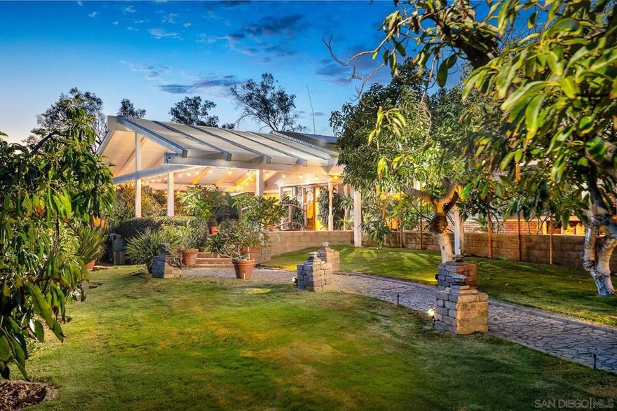 Step into a truly one-of-a-kind property where House, Guest House, Koi Ponds, Greenhouse, Solar, and so much more create a serene, tropical retreat.  The main house, spanning 2,743 square feet, welcomes you with a stunning bridge over a large koi pond and a beautiful lava rock waterfall. Inside, skylights throughout provide year-round natural light. The home features an oversized, 600+ square-foot master suite with a cozy pot belly stove, perfect for a private escape.  The entire property is powered by owned solar, making it an all-electric, eco-friendly home.  Stroll down the path and discover a breathtaking landscape adorned with staghorn ferns and plumerias, giving it a lush, tropical feel. The grounds are an edible paradise with a variety of fruit trees, including peaches, pears, plums, papaya, and mango, to name a few. For the aspiring gardener, plumbing is already in place for future growth. The path leads you past seven waterfall ponds filled with koi and to a tranquil greenhouse with two small ponds and another lava rock waterfall. An oversized tool shed and chicken coop provide additional space for hobbies and self-sufficiency.  The guest house, at 938 square feet, offers a private space for visitors. It includes two bedrooms, with the main bedroom upstairs opening to an outdoor deck perfect for watching the sunset. It also has its own pot belly stove for warm, cozy evenings. Attached is a spacious garage/shop with a carport, offering plenty of room for vehicles and projects.  This property is a sanctuary where comfort and nature blend seamlessly.