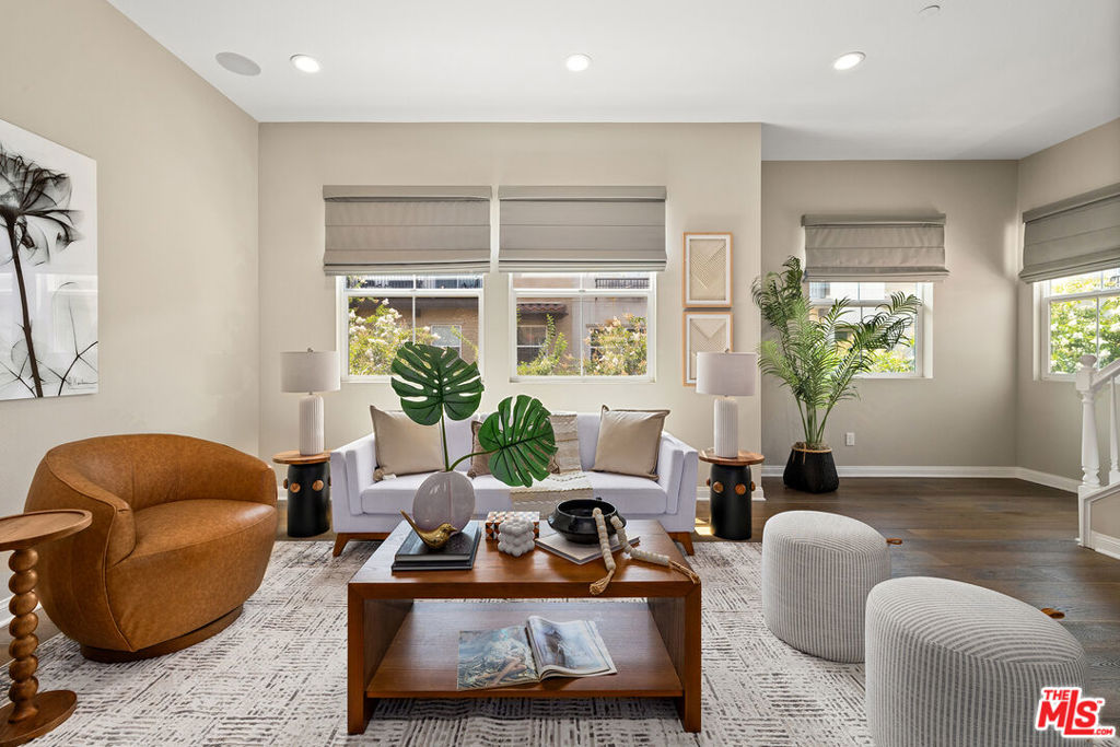 Bright, spacious, and loaded with high-end upgrades, this end-unit townhome features 3 en-suite bedrooms and a modern open floor plan. Enter through the gated front patio to find a first-floor suite with full bath, a laundry area with utility sink, and attached 2-car garage with EV pre-wiring & ceiling-mounted storage racks. The second level is open and airy, with soaring 10-foot ceilings and windows on three sides that flood the space with natural light. The kitchen features granite countertops, stainless appliances, a walk-in pantry, and access to a private balcony, while the roomy living and dining areas include a designer powder room and a rare additional closet. Upstairs, two more bedroom suites await with custom walk-in closet organizers - one suite with a cozy nook perfect for a home office, and a spacious primary with a spa-like bath, dual quartz vanities, a large glass shower, and water closet. Additional upgrades include wide plank wood flooring & tile throughout all living areas, recessed lighting, and pre-wired surround sound.
