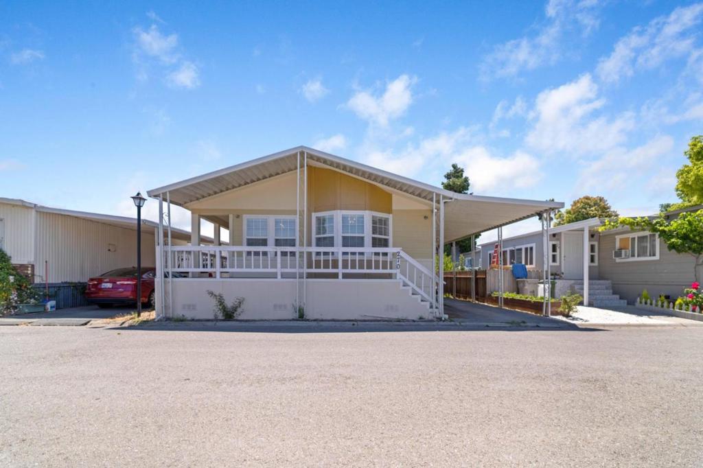 Step into a beautiful double-wide mobile home with 3 bedrooms and 2 baths. Approximately 1,527 square feet of living space. This home offers a spacious living room with high ceilings, a cozy fireplace, and tall windows that fill the space with natural light. Master bedroom suite includes recently-renovated bathroom. The kitchen has cabinets, newer granite countertops, plus an island. All kitchen appliances, along with a washer and dryer, are included. Separate formal dining room. Dining table and sofa may be included with a strong offer. There's central heating and ceiling fans. The carport accommodates up to three vehicles and guest parking is located close by. Conveniently nearby shopping centers and major freeways. Low space rent $1,079.86 per month.