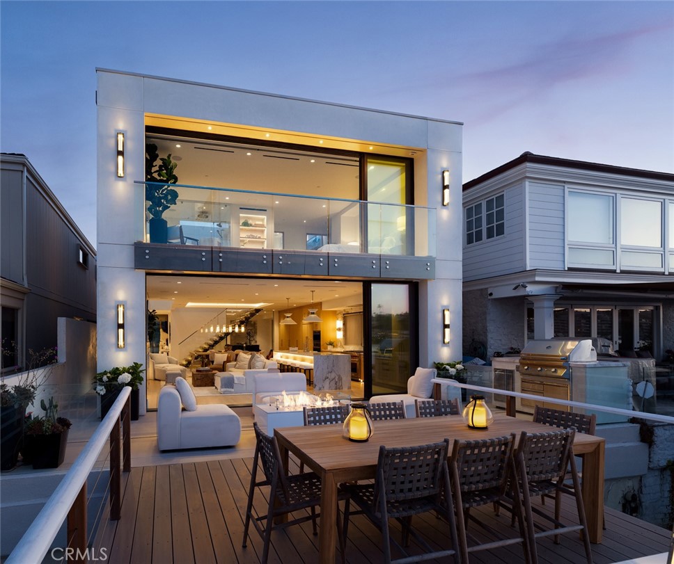 This newly completed bayfront masterpiece was taken down to the studs and meticulously reimagined, blending timeless modernism with architectural pedigree on Lido Isle’s most coveted stretch of waterfront. Honoring the vision of original architect Donald Knorr, the home showcases clean lines, abundant natural light, and a serene simplicity that defines elevated coastal living. At its heart is a one-of-a-kind retractable roof, the only one on Lido Isle, seamlessly merging indoors with out and creating an open-air experience unlike any other. Spanning nearly 3,000 square feet, the meticulously designed interior offers 4 bedrooms and 4 bathrooms, each finished with designer touches curated by the esteemed Barclay Butera. Highlights include a full Control4 home automation and security system, chef-grade Wolf appliances with dual dishwashers and a 48” range, a beverage center, built-in BBQ, and an expansive waterfront deck that extends the living space dramatically outward. With 32 feet of prime bay frontage, the private dock has been expertly reconfigured to accommodate a 65-foot yacht and a side tie for a Duffy, an increasingly rare offering. Just a short stroll from the upscale charm of Lido Marina Village and its world-class dining, shopping, and beaches, this residence isn’t just a home—it’s a redefinition of bayfront luxury living.