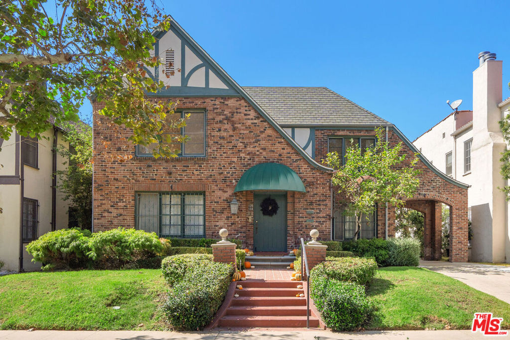 Charming, spacious, light-filled upper unit in English Tudor duplex nestled along tree-lined Orange Drive. Oak wood floors flow throughout. A sunlit living room with a fireplace and adjacent office opens to an elegant formal dining room featuring original built-ins, which seamlessly connects to breakfast room and a large, updated kitchen with abundant custom cabinetry, leather-finished granite counters and stainless-steel appliances. Hallway with multiple storage closets leads to three generously sized bedrooms, two updated baths with porcelain counters, and a laundry room. Outside, the shared backyard offers a sense of privacy among mature trees, along with access to a two-car garage. Located in one of Los Angeles' most desirable neighborhoods, close to Larchmont plus great spots like Sycamore Kitchen, Angelini Osteria & Republique. Third Street School District.
