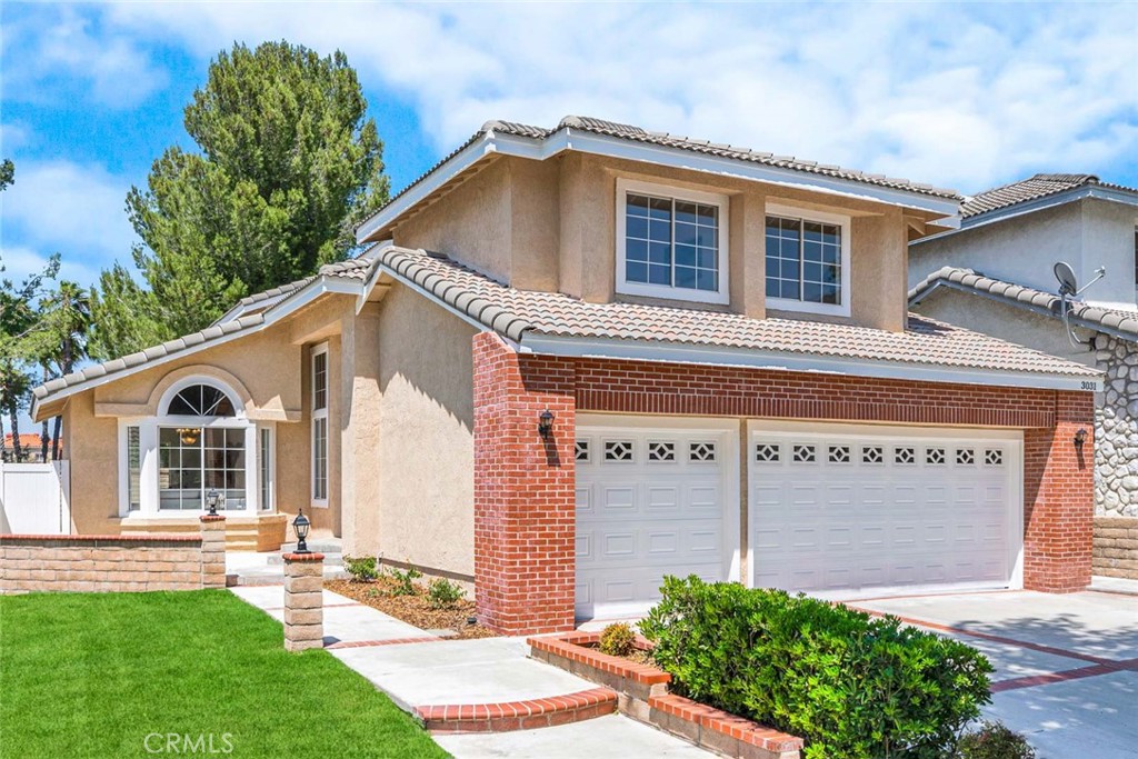 Welcome to 3031 Mountainside Drive, a Dream Home Located within the Highly Desirable Sierra Del Oro Community of Corona. This Move In Ready Home Showcases Four Bedrooms, Two and a Half Bathrooms, Soaring Ceilings, New Interior/Exterior Paint, New Interior Flooring, and Ample Natural Light Throughout. Upon Entry, You are Greeted with an Open Concept Living and Dining Room with a Vaulted Ceiling and Backyard Views. The Kitchen Sits Adjacent to the Dining Room and Enjoys Granite Counters, New Stainless Steel Appliances, and Breakfast Nook with Backyard Access. The Spacious Family Room Features a Cozy Fireplace and Opens to the Breakfast Nook, Perfect for Entertaining. The Expansive Primary Suite Features a Vaulted Ceiling, and Walk-In Closet. The Backyard is Complete with a Patio, Grass, and Large Seating Area. Direct Access Three Car Garage. Walk to Ridgeline Park and Prado View Elementary School. Minutes from Hiking, Shopping Centers, Restaurants, Multiple Parks, 15/71/91 Freeways, and 241/261 Toll Roads. No HOA and No Mello-Roos! 3031 Mountainside Drive is a Must See!