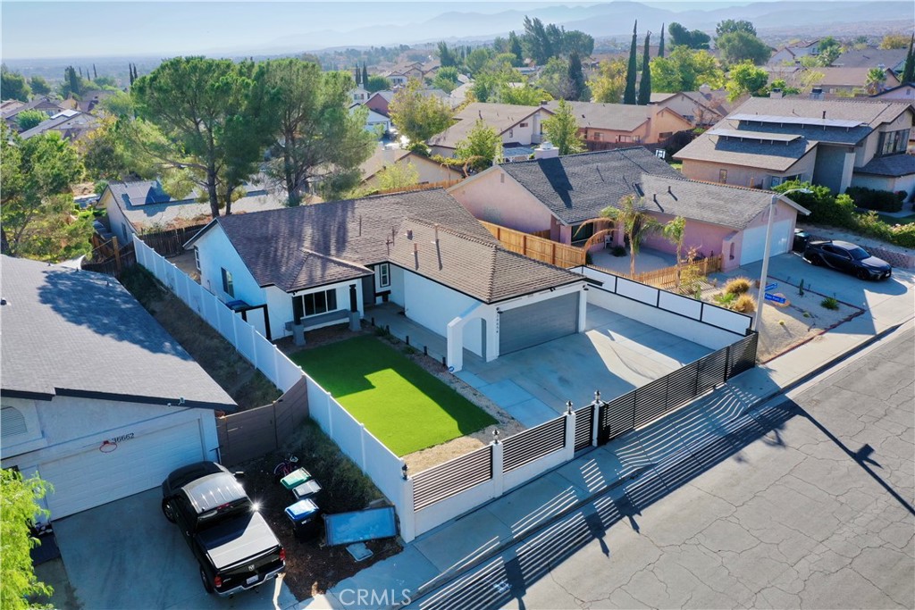 Located in Palmdale’s highly sought-after Joshua Hills neighborhood, this beautifully updated home combines modern style with everyday comfort. Featuring luxury vinyl flooring, quartz countertops, a farmhouse sink, a double sink vanity in the master bathroom, and an open-concept layout filled with natural light, the interior is both functional and inviting. The private, gated property includes fully turfed front and back yards, vaulted ceilings, wood finishes, and ample parking. Enjoy the convenience of a garage with a separate side entrance, ideal for a potential ADU or private workspace. Located just minutes from the freeway and near parks, hiking trails, and golf courses, this home also offers no HOA, new windows, security cameras, and thoughtful upgrades throughout—making it truly move-in ready.