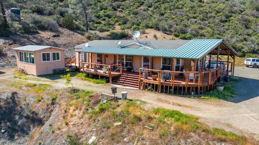 NEW PRICE ALERT! The 38+/- acreage near Frank Raines Regional Park offers not only stunning sunrise and mountain views but also a range of amenities tailored for comfortable living. The 2006 manufactured home, customized for the owner, with large walk-in pantry, mudroom, and a kitchen with an island. Custom desk/hobby area off the living room. The versatility of the space is evident with one bedroom doubling as an office, complete with French doors and bunk beds for added utility. The main suite offers privacy with its own bath featuring a soaking tub and separate shower Outdoor living is enhanced with a large covered deck area and an enclosed swim spa room. The lower portion of the property features a spacious 30'X60' insulated shop. RV cover with solar hookups adds practicality for outdoor enthusiasts, although the RV itself is not included. Overall, this property seems to offer a blend of comfort, functionality, and natural beauty, making it an appealing retreat for anyone seeking a serene lifestyle close to nature. Williamson Act.
