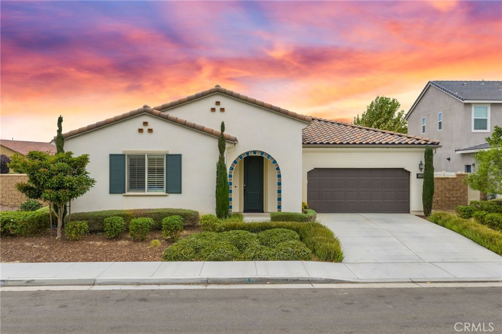 This home is more than just move in ready!. Stunning single-story home in the sought-after Spencer’s Crossing community boasts over $100,000 in builder and owner upgrades and sits on a corner lot. With 4 bedrooms, 2.5 baths, office/den and a flexible layout, it offers both privacy and open-concept living. Step inside to find three spacious bedrooms and a secondary bath, thoughtfully located on their own wing, separate from the private primary suite. The expansive great room features a cozy fireplace and flows seamlessly into the gourmet kitchen, complete with granite countertops, pendant lighting over the island, and extra recessed can lights on dimmers. A whole-house fan adds efficiency and comfort. The private primary suite is a retreat with direct backyard access through a sliding glass door, enhanced by motorized shades. The spa-like bath showcases dual vanities with quartz countertops, a large walk-in shower, and a walk-in closet with a double-sided mirrored door. A versatile flex room offers endless options as an office, den, or even a 5th bedroom. The laundry room is pre-plumbed with sink hookup and additional cabinetry. Designed for entertaining, this home includes a built-in home theater system with speakers extending to the covered backyard patio. Outdoors, enjoy low-maintenance turf, a second fireplace, dog run, and full wrap-around aluminum rain gutters. Additional highlights include partial plantation shutters and convenient garage keyless entry. Living in Spencer’s Crossing means access to resort-style amenities including pools, clubhouse, sports parks, trails, and The Oasis recreation center just around the corner. This home combines elegance, thoughtful upgrades, and community living truly a must-see!