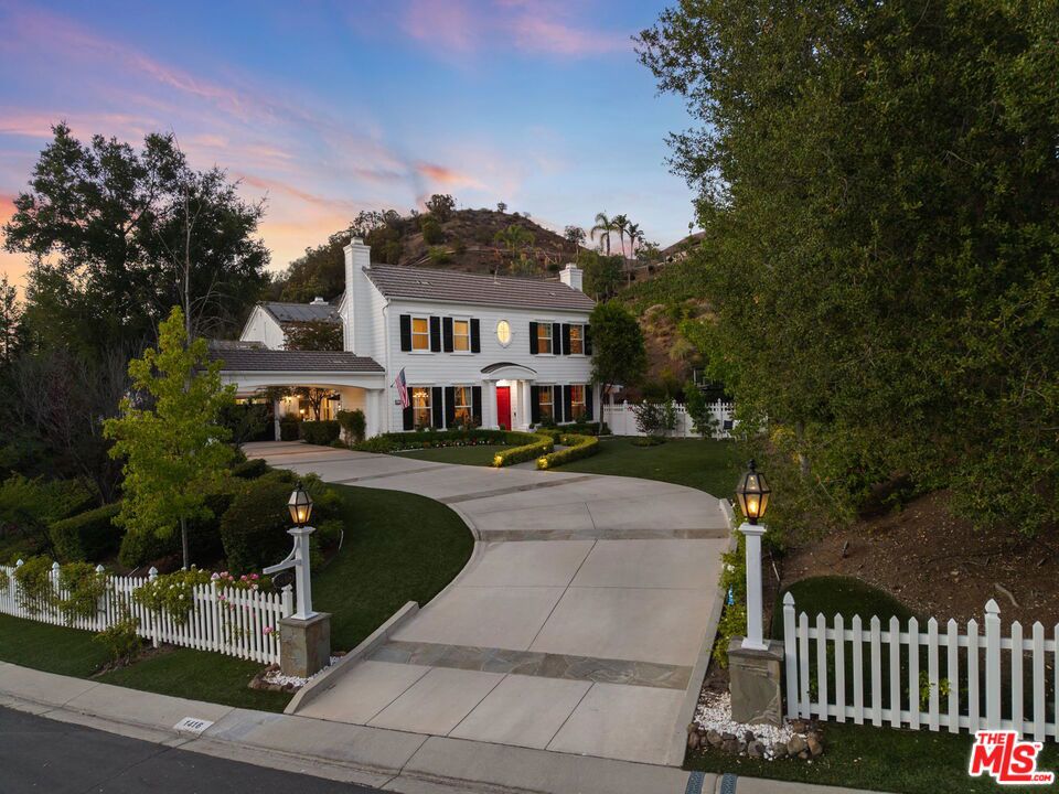 Welcome to a truly one-of-a-kind entertainer's paradise, ideally located in the heart of Westlake Village, one of Southern California's most coveted communities, celebrated for its top-rated schools and relaxed, upscale lifestyle. Set within a prestigious guard-gated neighborhood, this exceptional residence masterfully blends luxury, comfort, and show-stopping amenities throughout. At the heart of the home is a designer-remodeled kitchen featuring a breathtaking 13-foot Brazilian white marble island crafted from a single slab, paired with high-end appliances, including a Viking range with griddle and indoor grill, and a Halo 5 full-house water filtration system. The elegant interior also boasts a formal dining room with a fireplace, a fully enclosed office, an expansive primary suite with a peaceful seating area, a designer remodeled primary bathroom, a massive walk-in closet, and captivating views. Each bedroom is en suite and thoughtfully appointed with custom-built closets and dressers, offering refined style and everyday functionality. Step outside to your own private resort, where a large pool with a 40-foot waterslide, swim-up cave, and oversized jacuzzi takes center stage. Incredible canyon and hillside views can be seen from many vantage points of the expansive backyard. The outdoor amenities continue with three distinctive covered patios, a sports court, a wood-burning outdoor fireplace, and a side yard play area with artificial turf. The main backyard living space is an entertainer's dreamfully equipped with a TV, prep islands, sleek cabinetry, and a built-in barbecue and bar, ideal for gatherings of any size. A peaceful enclosed courtyard with a fire pit adds an intimate touch, while your very own Cabernet vineyard produces up to 400 bottles annually, creating a rare and luxurious lifestyle experience. Additional highlights include paid-off solar panels, a Tesla charger, a steam shower in the primary suite, low-maintenance artificial turf landscaping, a laundry room with a brand-new front-loading washer and dryer, and a climate-controlled wine cabinet capable of storing over 400 bottles. This extraordinary estate is the ultimate expression of luxury living in Westlake Village and must be seen to be fully appreciated. Don't miss your chance to tour this one-of-a-kind home before it's gone.