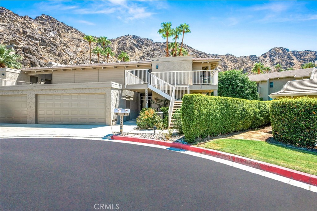 Experience refined desert living in this beautifully appointed 2 bedroom, 2 bath condo in prestigious Mountain Cove, Indian Wells. Nestled beneath the breathtaking Santa Rosa Mountains, this home offers stunning views and a serene backdrop for desert living. Offered fully furnished with exquisite Kreiss furniture, this residence combines elegance with comfort in every detail. The open concept living room, dining and kitchen spaces are filled with natural light and flow seamlessly to private patios, perfect for entertaining or everyday living. Sliding glass doors from the living room to the outdoor patio creates an incredible ambiance for indoor outdoor living and alfresco dining. The living room has a sleek TV setup, plush seating couches and a cozy fireplace creating the perfect blend of comfort and style. The dining room table can comfortably seat six and more sliding glass doors to the BBQ patio where outdoor grilling can take place. The kitchen is well equipped with a refrigerator, oven/range top, brand new dishwasher and microwave. Plenty of counter space with room for serving or barstools for casual eating. Next to the kitchen is an extra-large laundry room with a brand-new washer and dryer, overhead cabinets and room for more shelving or storage. The owner’s primary bedroom is designed as an inviting retreat with a king size bed and nightstands, a huge walk-in closet and sliding glass doors to an outdoor patio where you can enjoy your favorite morning and evening beverage. The ensuite bathroom showcases granite countertops, a custom-made vanity, expansive shower tub combo and a private water closet for ultimate privacy and comfort. The 2nd bedroom is also an inviting retreat with sliding glass doors to the patio atrium and tons of light coming through. There is ample closet space for all your clothes and shoes and access to an ensuite bathroom. The 2nd bathroom with a custom furniture vanity and a nice size walk in shower round out the interior of this amazing condo. The sophisticated furnishings and thoughtful design make this home fully turnkey and move-in ready. The patios overlook gorgeous rolling lawns and trees, and the heated community pool is just a few steps away. As a resident of Indian Wells, enjoy a 20% discount at select restaurants, spas and hotels and a discounted golf rate at the Indian Wells Country Club. The Indian Wells Tennis Garden is nearby as well as the El Paseo shopping and restaurants. ~ Welcome Home ~