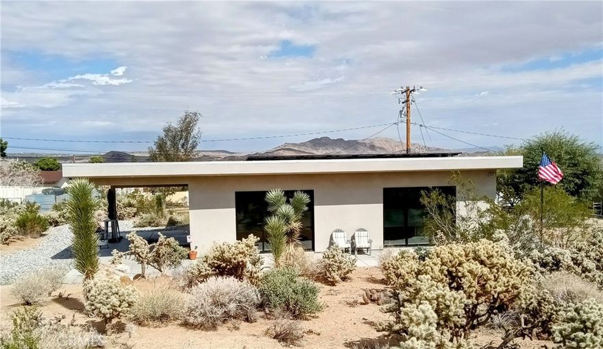 This Property Is Minutes From Joshua Tree National Park.  It Was Custom Built In 2021 With An Open, Spacious And Modern Design.  It is Turnkey.  It has Italian Tile Throughout.  The Living Room Has Large Dual Sliding Glass Doors Provide A Beautiful View of The Front Yard With Its Natural Desert Landscape.  Each Room Has A Dual Pump So You Can Set The Temperature To Your Preference, As Well As Ceiling Fans In Each Room. The Kitchen Has A Large Island That Opens Up To The Living Room To Give It That Spacious Quality.  This Property Is Perfect For An Owner Occupied Residence, A Vacation Home Or An Airbnb.  This Property Is Move-in Ready To Enjoy All That Peaceful Desert Beauty That Joshua Tree Has To Offer.