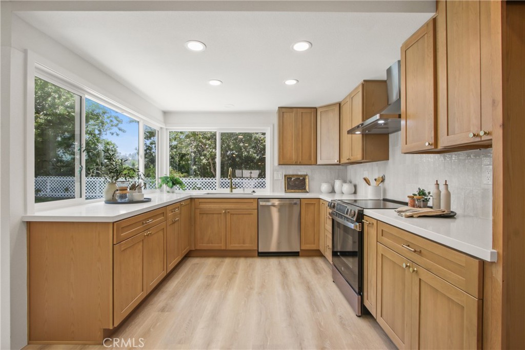 LUXURY LIVING IN LAGUNA HILLS! Step into STYLE and COMFORT in this STUNNING 4-BEDROOM REMODELED HOME nestled in one of Orange County’s most sought-after communities. From the moment you walk in, you're greeted by WIDE PLANK luxury vinyl floors and a bright, open layout that radiates warmth and sophistication. The heart of the home is a SHOWSTOPPER kitchen featuring rich, warm-tone shaker cabinetry, gleaming white quartz countertops, and elegant champagne hardware—perfect for hosting or just sipping your morning coffee in style. Retreat to the PRIMARY SUITE—your own private sanctuary with an OVERSIZED California closet and a spa-inspired bathroom that boasts a FREE-STANDING soaking tub and serene finishes that whisper “relax.” With 4 spacious bedrooms, every family member or guest will have their own space to unwind. Every inch of this home has been thoughtfully redesigned for MODERN LIVING with TIMELESS CHARM. Don't miss your chance to own this slice of SoCal luxury. Welcome home to Laguna Hills—where your next chapter begins!
