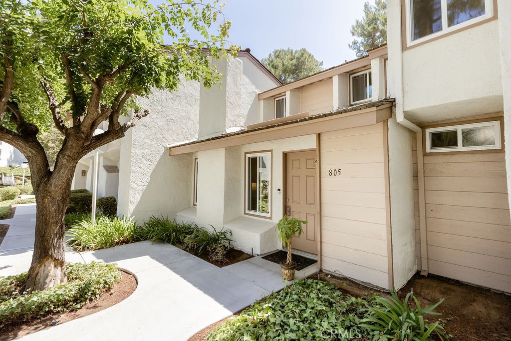 Welcome to 805 Vista Court, a 3 bedroom, 2.5 bath townhome situated in a prime location in the highly sought-after and well-established Country Road community in the beautiful City of Brea. This property has a front row view of the community pool, is surrounded by mature trees and lush vegetation and gets a refreshing afternoon breeze which flows through the home. As you enter, you will notice the vaulted ceiling, cozy brick fireplace, dual pane windows, fresh paint, spacious dining area, private patio, convenient downstairs powder room, and direct access to the two-car garage. This home is well-equipped with a Samsung refrigerator, complete with water and ice in the door, Bosch dishwasher, GE microwave and GE stove with a double oven including an air fryer and griddle. In addition, the Maytag washer and dryer are such a nice bonus! The primary bedroom, also with a vaulted ceiling, allows natural light to fill the room and the en-suite bath, walk-in closet and ample counter space complete this private sanctuary. This community is conveniently located within a very short distance to all the City of Brea proudly offers: Excellent Schools, the Brea Mall, Community Center, Senior Center, Sports Park, Brea Downtown, The Tracks at Brea Trail, the Skate Park, Wildcatters Dog Park, and a wide variety of Dining Establishments, Entertainment Venues, Parks and Shopping. There is something for everyone!