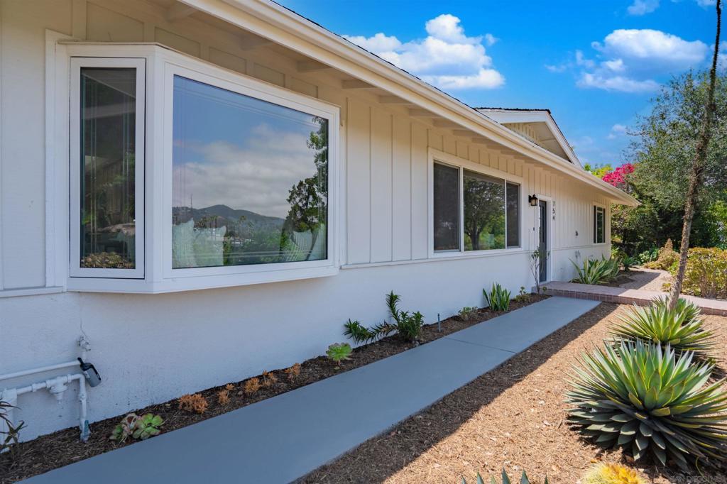 Tucked at the top of a peaceful cul-de-sac, this San Marcos hilltop sanctuary offers unmatched privacy and panoramic views that stretch across the rolling hills. Imagine waking up to glowing sunrises and ending your day with postcard-worthy sunsets—every day here feels like a retreat. Thoughtfully updated and remodeled, the home blends modern comfort with timeless appeal. Mature landscaping surrounds the property, creating a calming green oasis, while the interior layout flows effortlessly—perfect for everything from quiet mornings to lively gatherings. An eco-friendly solar system keeps energy costs low, and the rare bonus of generous RV and guest parking means you can welcome friends and family with ease. If you're searching for a view home in North County that offers tranquility, functionality, and stylish upgrades—this one checks every box.