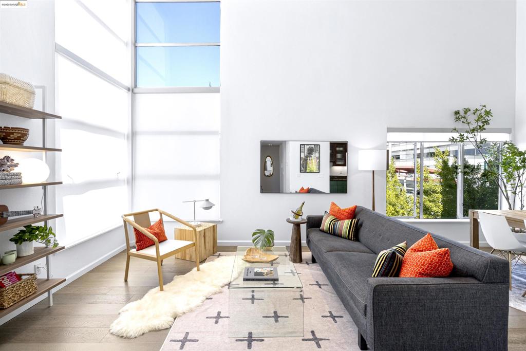 Chic, sophisticated, premium corner loft with Bay and SF views is the ultimate in city-centric living. Luminous San Francisco-style condo has all the conveniences at your literal doorstep: Dining, shopping, transportation, recreation – yes, yes, yes! Here is where you’ll experience the heartbeat of Emeryville. Inside, you’ll find sky-high ceilings, vast windows, unbeatable natural light, clean lines, modern spaces and a smart floorplan with seamless rapport between kitchen, living/dining rooms, laundry and half-bath. Upstairs, create a home office or guest space in one of the bedrooms, and luxuriate in the primary suite with its private deck and shimmering views. Sited on the Emeryville Greenway with pretty grounds, dedicated parking and low dues, this is a well-known special HOA. Steps to Townhouse Bar & Grill, Honor Kitchen, The Bureau 510, Cafe Buenos Aires, Polaris Cafe, Doyle Street Cafe, Branch Line Kitchen, Compound Gallery, Amtrak, Stanford Health Care, Novartis and so much more. Also close to Emeryville Public Market, Bay Street, Trader Joe’s, Emeryville Marina, Pixar and the exciting future Sutter Health campus.