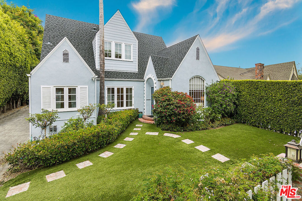 This timeless home blends traditional storybook architecture with today's modern comforts, all located in one of West Hollywood's most desirable neighborhoods. The main residence offers 3 spacious bedrooms and 3.5 bathrooms, including a sun-drenched formal living room with vaulted ceilings, a dramatic stone fireplace and beautiful wood floors. The updated kitchen features stainless steel appliances, an eat-in dining nook, custom cabinetry and a seamless connection to the dining area for easy entertaining.The detached guest house includes a full bedroom, bathroom, kitchen and a generous living area; perfect for home office, visitors, in-laws, or potential rental income.The gated property features beautiful curb appeal including manicured landscaping, privacy hedges, a driveway for over 4 cars, and a detached 2 car garage. A wonderful location, just moments from Melrose, Robertson, and Santa Monica Boulevards; enjoy the best of LA living with premier dining, nightlife and shopping.