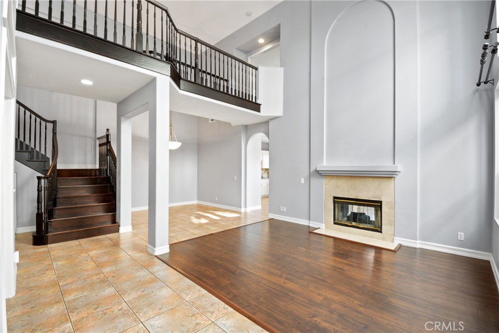 Stunning 4-bedroom, 3-bathroom home in the prestigious gated community of Eagle Pointe. This beautifully upgraded residence is the largest model in the tract, offering a perfect blend of luxury and functionality. The main floor features a convenient bedroom and full bath, ideal for guests or multigenerational living, while the large upstairs loft provides flexibility for an office or bonus space. Step inside to soaring cathedral ceilings and an open-concept living and family room, connected by a charming dual-sided fireplace. The gourmet kitchen boasts granite countertops, abundant cabinetry, and stainless steel appliances, perfect for culinary enthusiasts. Designer floor tiles and laminate wood flooring flow throughout, complemented by granite countertops and a luxurious master suite with private and scenic views. The secluded backyard is an entertainer’s dream, tastefully designed for seamless indoor-outdoor living. Enjoy access to the Eagle Pointe community’s pool and spa within a gated setting along with multiple nearby community parks and walking trails. Located near award-winning schools, shopping, dining, major freeways, 73 toll road, and beautiful beaches, this home offers both convenience and tranquility. Don’t miss this opportunity - Schedule a viewing today!