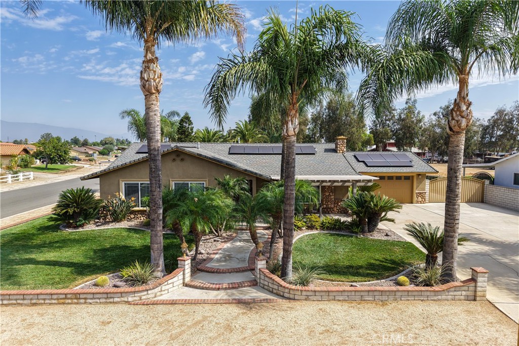 Discover your own private equestrian paradise on nearly half an acre! This exceptional 4-bedroom, 2-bathroom single-story home is nestled on a peaceful cul-de-sac in desirable Jurupa Valley. With 1,749 square feet of thoughtfully designed living space and an expansive 20,473 square foot lot, this property offers the perfect blend of luxury living and rural charm.
Step inside to discover elegant crown molding and beautiful laminate flooring throughout, complemented by modern recessed lighting and surround sound system. The spacious living room centers around a cozy fireplace, creating the perfect gathering space for family and friends. The chef-inspired kitchen is a true showstopper, featuring stunning granite countertops, designer backsplash, stainless steel appliances, convenient double ovens, and abundant cabinet storage. Both bathrooms have been upgraded with granite countertops and luxurious shower installations.
The backyard is an entertainer's oasis featuring a built-in BBQ with sink and relaxing spa. Mature palm trees provide natural beauty while an abundance of fruit trees offer fresh apples, lemons, limes, pomegranates, pears, guava, and exotic dragon fruit right in your backyard. Horse enthusiasts will love the horse stalls and spacious storage shed.
The convenient washer and dryer hookups in the garage add everyday convenience. RV parking accommodates your recreational vehicles or additional storage needs. The generous lot size offers endless possibilities - perfect space to add a swimming pool, build an ADU for additional income potential, or simply enjoy the open space.
Additional benefits include no HOA fees, low property taxes, and the paid-off solar system for immediate energy savings. Situated in a quiet cul-de-sac location offering privacy and safety, yet convenient to shopping, dining, schools, and major transportation routes. Jurupa Valley provides the perfect balance of rural living with urban accessibility. This unique property combines luxury living, equestrian amenities, and incredible value - a rare find in today's market!