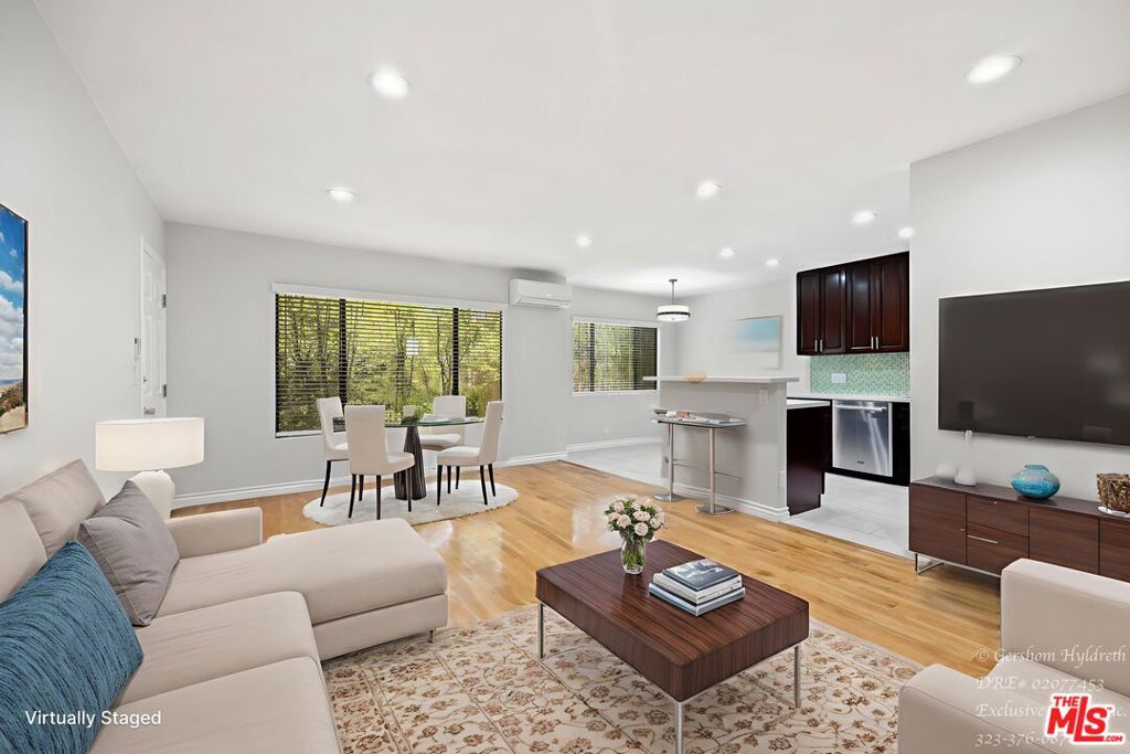 Modern Spacious First-Level 2BR Open Layout, Tons of Light, Move-In Ready! Live in comfort and style in this bright, open-concept 2-bedroom apartment featuring real wood and tile floors throughout. Perfect for entertaining or relaxing, the kitchen includes a stool-accessible counter, granite countertops, stainless steel refrigerator, microwave and stove. Sunlight pours in from large windows, highlighting modern lighting fixtures and creating an airy, inviting atmosphere. Apartment Features: Open-concept living and kitchen layout with ample natural light - Real wood and tile flooring throughout for easy maintenance - Brand new ductless mini-split AC & heater for year-round comfort - Spacious bathroom with 2 sinks. Large closets in both bedrooms & the living room has a walk-in closet for plenty of storage. Community laundry room with coin or coin-less options. 2 car tandem parking space. This home offers more than just an apartment - it's a lifestyle. Located in a vibrant neighborhood, you're just minutes from local shops, cafes, and markets, perfect for quick errands or casual dining. Enjoy outdoor recreation with nearby parks and hiking trails, or explore cultural and entertainment spots like theaters, galleries, and live music venues. Quick access to major transit routes makes commuting or exploring Los Angeles easy, while the quiet, residential setting ensures peace and privacy. Experience convenience, comfort, and the perfect mix of city energy and residential calm. Ready to move in now! VIRTUAL WALK-THROUGH