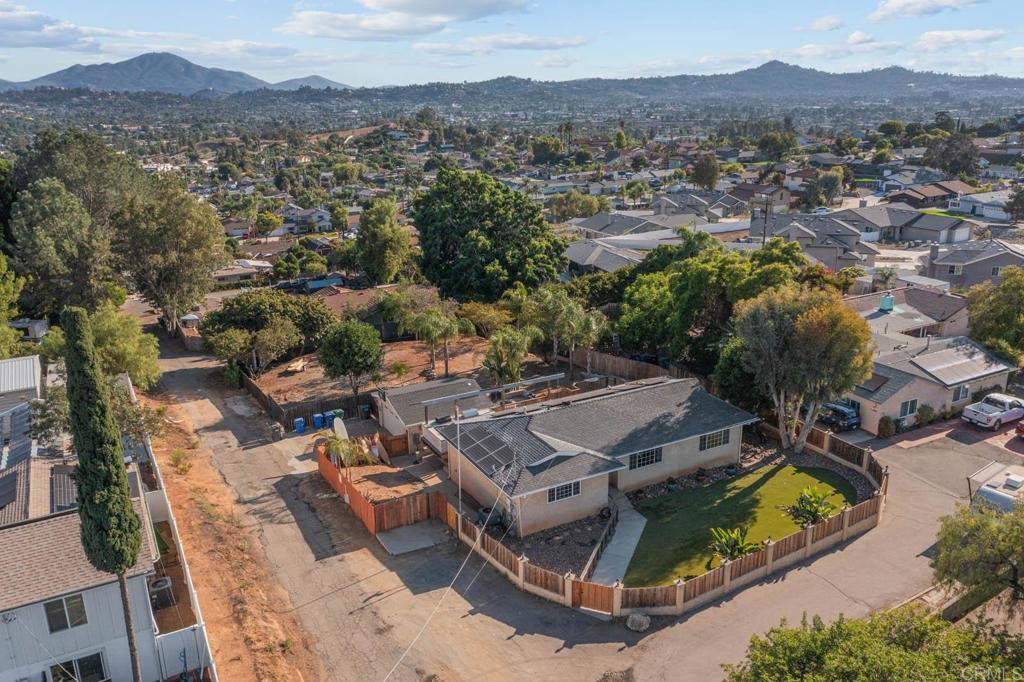 Discover your dream home in the vibrant heart of El Cajon, where breathtaking views meet unparalleled comfort. This charming three-bedroom, two-bath residence is nestled on a generous 0.44-acre lot within the esteemed Grossmont Union High School District. 2 car garage with space outside for more cars. Imagine summer nights in your beautifully large backyard, complete with a cozy fire pit and a built-in barbecue island—perfect for entertaining. Eco-conscious living is a breeze with 20 fully paid solar panels, ensuring energy efficiency and savings. The heart of this home is its stunning kitchen, featuring a stylish island and brand-new, state-of-the-art appliances, including a refrigerator, stove, microwave, and dishwasher.