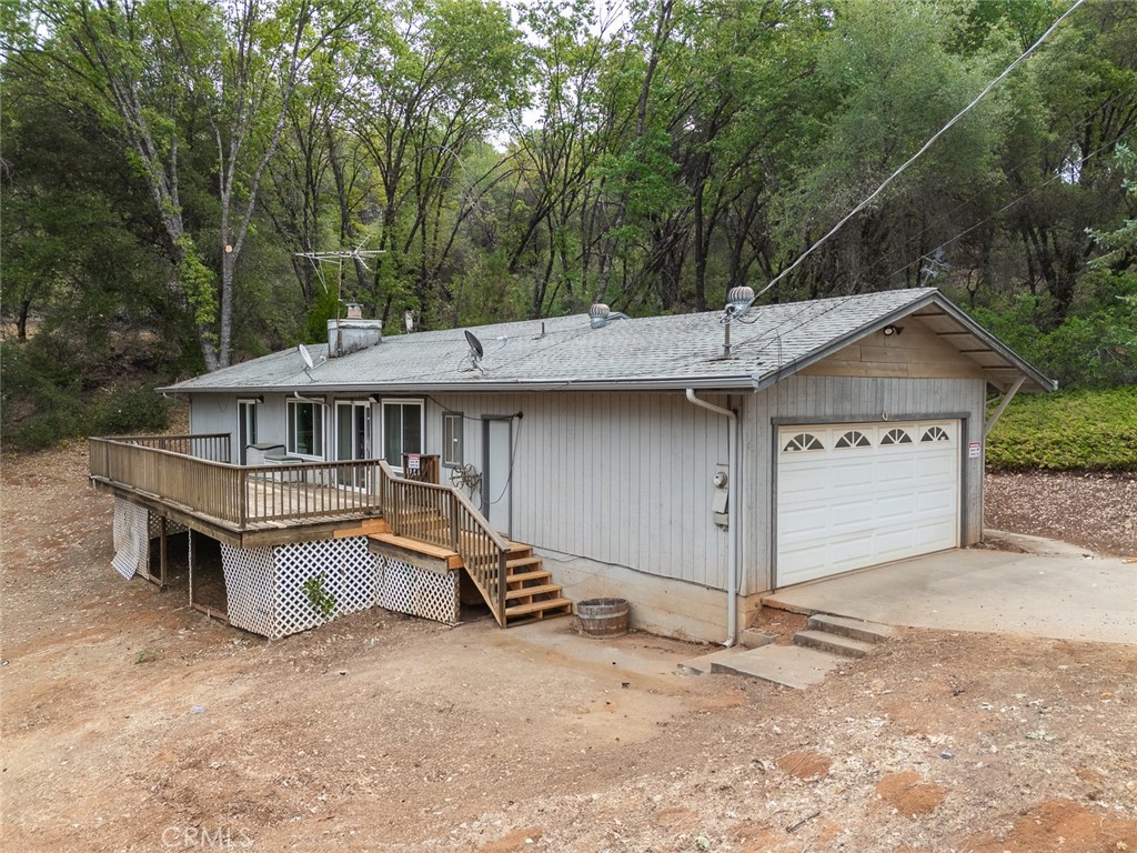 This unique Grass Valley property offers the perfect mix of privacy and convenience. The home has three bedrooms, two bathrooms, a two-car garage, and sits on ten acres with plenty of space to spread out. Inside, with brand new vinyl plank flooring installed already, it could use some cosmetic updates, which makes it a great opportunity to add your own touches and style. A spacious deck looks out over the land and beautiful views, giving you the perfect spot to relax or entertain. The setting is quiet and private, yet you're still just a short drive to town and everything you need. With room for parking, storage, and outdoor living, this property feels like a retreat while keeping you connected to the best of Grass Valley living.