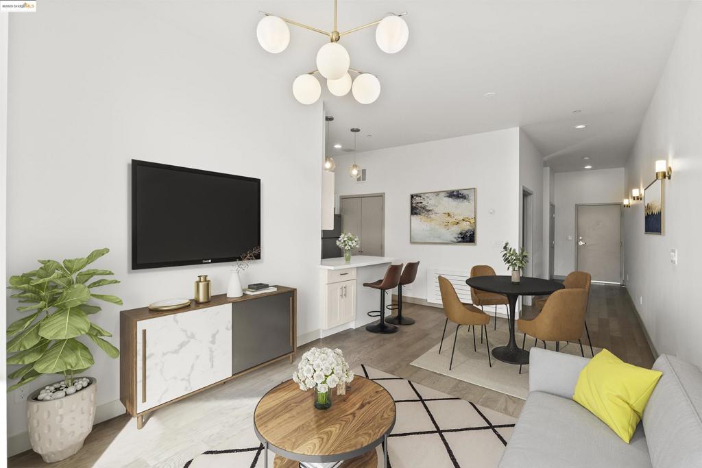 This move-in-ready contemporary condo is priced to sell and perfectly placed in the heart of Oakland’s vibrant Jack London Square. Inside, soaring eleven-foot cathedral ceilings, expansive custom sliding doors, and oversized windows flood the living area with natural light, creating a bright and welcoming atmosphere. The stylish kitchen features stainless steel appliances, a sleek backsplash, soft-closing cabinetry, and a peninsula island ideal for casual dining or gathering. Conveniently tucked next to the kitchen is your in-unit laundry, complete with room for shelving and extra storage. The bathroom feels like a private retreat with a floating vanity and spa-inspired tile shower. A private balcony provides the perfect spot for morning coffee or evening relaxation. The community rooftop deck includes seating areas, BBQ grills, and charming planter boxes. Parking is simple with your designated space in the secure, gated garage. All of this comes with unbeatable access to BART, the ferry, the farmers market, restaurants, parks, and Chinatown—delivering the ideal blend of comfort, convenience, and urban lifestyle. Views: Downtown