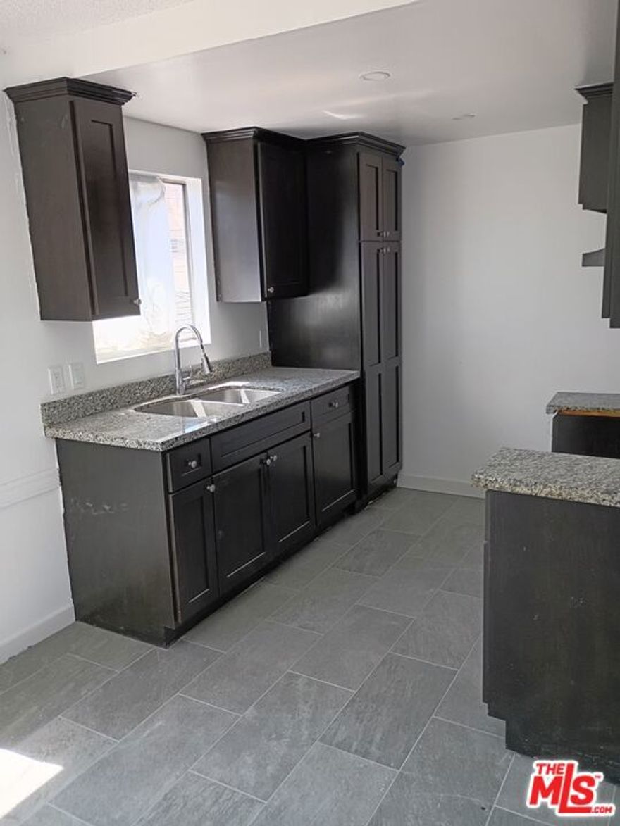 Freshly remodeled three bedroom one bathroom unit with two gated parking spaces.