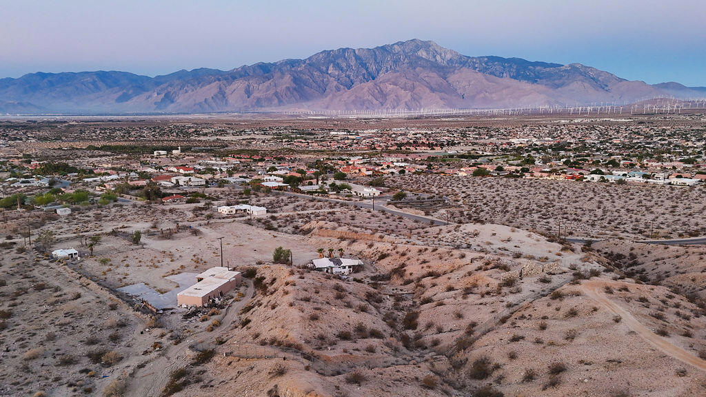 Endless Possibilities in the Spa Zone - 4.5 Acres on Miracle Hill! An extraordinary opportunity awaits in the heart of Desert Hot Springs' world-renowned Spa Zone. This combined 4.5-acre parcel--consisting of a 3.5-acre and a 1-acre lot--is zoned Commercial-Visitor or Multi-Use, offering flexibility for a residential subdivision, boutique hotel, wellness retreat, or spa resort.Once part of the historic Cabot Yerxa Estate, the property is rich with story and soaked in healing hot mineral waters. Located on the elevated north end of Miracle Hill and Pierson, it offers sweeping views, electricity on-site, a private well, and two separate APNs being sold together. Although there are two small abandoned structures and a trailer on the property, the value is in the land and location--a blank canvas for your vision to come to life. Bonus: Seller financing is available--a rare chance to secure a property with so much promise and potential.Inspiration plans for a spa retreat available.This is more than land--it's a legacy in the making.