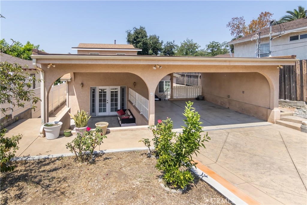 Welcome to 10233 Glory Ave, a beautifully reimagined home in the heart of Tujunga. This charming 3-bedroom, 2-bathroom residence has been thoughtfully and thoroughly remodeled from top to bottom. Nearly every major system has been upgraded, including a brand-new roof, updated electrical, plumbing and HVAC systems, offering a truly move-in-ready experience. Step inside to discover a bright, open-concept layout featuring a fully renovated kitchen with sleek cabinetry, premium tile countertops, stainless steel appliances, a center island, and a cozy breakfast nook or office space. The living room is warm and inviting, enhanced by recessed lighting, classic baseboard moldings, and French doors that open to a private front patio, perfect for relaxing or entertaining. Designer finishes throughout the home including laminate flooring, stylish lighting, and tastefully updated bathrooms. The spacious primary bedroom is conveniently located on the main level and includes a beautifully remodeled en-suite bathroom, offering comfort and accessibility. Upstairs, the secondary bedrooms are generously sized with ample natural light and closet space. Outside, the home features a two-car covered carport, extended driveway with RV access, and easy-care landscaping. Located on a quiet street in a peaceful Tujunga neighborhood, this home combines timeless character with modern upgrades and is close to local parks, schools, shopping, and hiking trails. This is a rare opportunity to own a fully remodeled, turnkey home—schedule your private showing today!