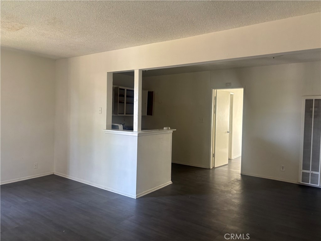 Upstairs one-bedroom, one-bath unit. Features fresh paint and hard flooring throughout. Bright and inviting with a spacious walk-in closet. Bathroom includes a shower over tub. The kitchen is equipped with granite countertops and a freestanding stove. Assigned one Carport.