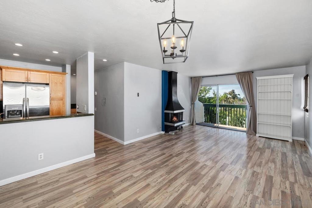 Welcome to this charming single-level corner condo, offering comfort, convenience, and style. This light-filled home features laminate flooring, recessed lighting, and an updated kitchen and bathroom with granite countertops. The kitchen is thoughtfully designed with pull-out shelves, while the bedroom includes a custom built-in closet system for extra storage. Enjoy a private balcony with a peaceful, westerly canyon view and a peek-a-boo glimpse of the bay. The spacious bedroom offers oversized closets, with an additional large closet in the dining area. Located on the entry-level second story, this unit has no stairs to access and no one living above. Perfectly situated less than a mile from the new Balboa Transit Station, and within a short distance to a local restaurant and coffee shop, this home combines modern upgrades with everyday convenience.