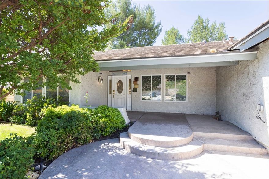 This Single Story home is nestled amidst gently rolling hills in the prestigious neighborhood of Vista Ridge, Valencia, and with the BONUS of the seller willing to assist with buyer's closing cost or interest rate buydown, this is an awesome deal. Here are a few of the main house's fine features: Lush landscaping, manicured planters, mature shade trees, and custom hardscape enhance its eye-catching curb appeal *You'll step into a flowing 1,938 square foot open concept floor plan that is in "Pristine Condition" with vaulted ceilings, recessed lighting, and an aesthetic blend of wood, tile and plush carpet flooring * The spacious living room is bathed in natural light from large picture windows * The family's chef is going to truly appreciate the stunningly updated kitchen's abundant custom cabinets with counter lights, ample granite counters with full back-splash, large center island with built-in breakfast bar, gas cooktop with custom ventilation hood, built-in stainless steel appliances, and the convenience of the adjoining dining room * The family room has mantled fireplace and direct patio access * All 4 bedrooms have effi­cient ceiling fans; The grand suite also has direct backyard access, a large walk-in closet, and a sumptuously appointed custom tiled bathroom with dual sink mirrored vanity, soothing spa tub, and glass enclosed shower * A total of 2 bathrooms * Functionally located laundry * Energy effi­cient dual pane windows will help keep your utility bills low and the interior very quiet * Central air & heat * You're going to appreciate the backyard's privacy fencing, lush landscaping, and covered stamped concrete entertainer's patio * New ADU's features: *429 square foot studio floor plan with vaulted wood-beamed ceiling, recessed lighting and laminate flooring * Well appointed kitchen with abundant cabinets, quartz counters, durable stainless steel sink, and built-in stainless steel appliances, and breakfast bar * Stackable laundry area * 1 bathroom * ADU is perfect for potential rental income, college student, traveling nurses, or perhaps you have and elderly loved one you'd like to have close by to help and avoid the high costs and risks of an assisted care facility *Experience Enjoy the community's, sparkling pool, 2 spas, plus the tennis and pickleball courts * Great location close to award winning schools, shopping, fine dining, Vista Valencia Golf Course, and the 5 freeway