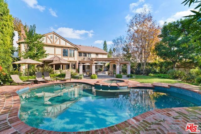 Beautiful updated contemporary estate with 5 bedroom, 7 bath in prime Beverly Hills flats on large 14,556 ft lot. Grand 2 story entry with formal Living and Dining rooms. Fabulous open Kitchen w/granite counters, top of the line appliances, large center island and adjoining breakfast area open to sun drenched Family room all overlooking the lushly landscaped resort style backyard with large pool and spa. Guest suite plus a Den complete the first floor. Lavish Master suite boasts large sitting area, balcony, his & her baths and walk in closets, plus 3 large family en suite bedrooms complete the second level. Set back from street with circular driveway and 2 car garage. Private, quiet and walking distance to theater, shops, restaurants and all BH has to offer.