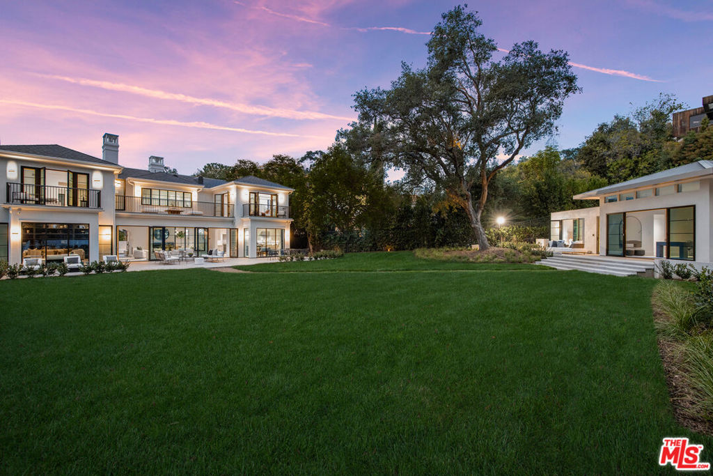 Discover the epitome of luxury living in the heart of Brentwood. This newly constructed, custom-built Transitional gem, crafted by architect Ward Jewell, AIA and built by Gordon Gibson Construction, boasts meticulous attention to detail. Sophisticated interior design by Jeffrey Hitchcock guarantees quality in every corner. Set upon a vast 18,316 square foot lot, this stunning home provides ample space for modern living and high-end hosting. Fleetwood doors and windows throughout the home invite an abundance of natural light to fill the interiors, blurring the line between indoor and outdoor living. Designed for culinary excellence, the kitchen features top-of-the-line Wolf and Sub-Zero appliances, plentiful counter space, a boundless butler's pantry with temperature-controlled wine column, plus a separate walk-in food pantry. The office/library and formal living and family rooms provide versatile spaces for both work and relaxation. Upstairs, the primary bedroom provides an airy ambiance unveiling a breathtaking view of the expansive backyard. Highlighting a spa-like bath and dual closets, the primary suite harmoniously combines opulence with practicality. Three additional en-suite bedrooms complete the upstairs. The gorgeous exterior features an extensive, meticulously kept lawn, mature hedges, and majestic oak tree. A large outdoor patio, covered in limestone, creates the perfect atmosphere for alfresco dining and entertainment. Across the lawn awaits an expansive guest house with abundant living space, bedroom, full bath, plus kitchen and laundry. Separate from the 2-car garage, a gated driveway offers additional space and unmatched privacy for vehicles. Control4 Smart Home technology with surveillance ensures high level security and peace of mind. With its expansive lot, this property offers an incredible canvas for an unparalleled living experience. Adjacent to this property, discover 572 N Bundy Drive for sale, presenting a rare opportunity to acquire a generational compound in prime Brentwood.