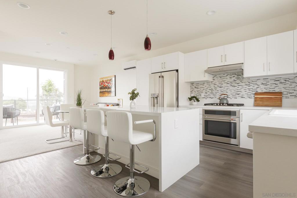 New Construction - this is one of the last units available in the development! The brand new Cantera neighborhood is located within walking distance of the Spring St trolley, Collier Park & the vibrant La Mesa Downtown Village. Enjoy stunning views, while also ensuring privacy from the hustle and bustle of city life. With a modern design, this beautiful home boasts two bedrooms and 1.5 baths, offering both comfort and convenience. The gourmet kitchen is a chef's delight, featuring top-of-the-line stainless steel Cafe appliances, sleek quartz countertops, custom cabinets (made in Germany, designed by DNA Design Group), luxury vinyl plank (LVP) flooring, soft-close drawers, and a waterfall style island, which is perfect for both cooking and entertaining. Custom tile and soaking tubs add a touch of luxury to the bathroom. The home's eco-friendly features include paid-for solar panels, allowing for energy-efficient living, and a mini-split AC/heat system that allows you to control each floor separately. Outside, each unit features a patio, a state-of-the-art glass carport (with UV protection), 2 driveway spaces & is wired for EV charging. Complex is FHA & VA approved. Photos are of a similar model unit with the same floor plan. Construction is complete, this unit is ready for moving in! The Cantera community epitomizes upscale, eco-friendly living in a uniquely designed neighborhood that blends modern luxury with natural beauty. Situated in a former rock quarry, each home within Cantera offers stunning views and privacy, yet is just a walk away from the Spring Street trolley, vibrant La Mesa Downtown Village, and Collier Park, where residents can enjoy a diverse mix of local shops, trendy cafes, and gourmet restaurants. Outdoors, private patios and native plant landscapes create personal retreats amidst natural rock formations. Cantera combines the serenity of its natural surroundings with the convenience of urban living, making it an ideal choice for those seeking a luxurious, energy-efficient home in a prime location.
