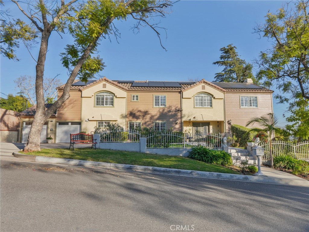 Welcome to this prestigious home in the highly sought after City of Sierra Madre. This luxurious home boasts 5 bedrooms, (one of the bedrooms located on the main floor), a in home office with built in shelving that could be used as a 6th bedroom if desired. The home also features 4 full baths with one full bath on the main floor. The home is situated on an absolutely stunning and private lot, with several fruit trees and incredible views of the city lights. As you enter into the formal foyer you have a view of the solid white oak wood curved staircase, and grand chandelier. The first level of home features solid oak wood floors throughout which were recently refinished. As you enter the home to the right there is a step down into the formal Great Room featuring a cozy fireplace for your formal dinning and entertainment needs. Just off off of the family room the kitchen awaits it is every chefs culinary dream, the kitchen is equipped with double ovens, a 6 burner cook top, a sub zero refrigerator and freezer, tons of cabinetry for all of your storage and organization needs. Step up into the family room which offers a spacious area for family gatherings and movie nights. The second level of the home offers a gracious primary suite with walk in his and her closets, not to mention the ensuite with a jacuzzi style tub, and large walk in shower. Just down the hall you will find an additional 3 bedrooms, on the farthest wing you have a jack and jill suite with a shared bathroom. The home was meticulously designed featuring a whole house vacuum system, fire sprinklers, and the entire down stairs ins wired to operate off of a generator in the event of a power outage or emergency (generator is not included). The backyard is nothing short of an Oasis, with the serenity of the Koi Pond and Waterfall offering a very tranquil and relaxing atmosphere with tons of privacy and the serene views of the flowers and neighboring trees. The perfect place to enjoy your morning coffee or it is suitable to host all of your entertainment events. This home offers the ultimate luxury lifestyle and is conveniently located near the quaint downtown, scenic hiking trails and is situated within close proximity to shopping, freeways and grocery stores.
