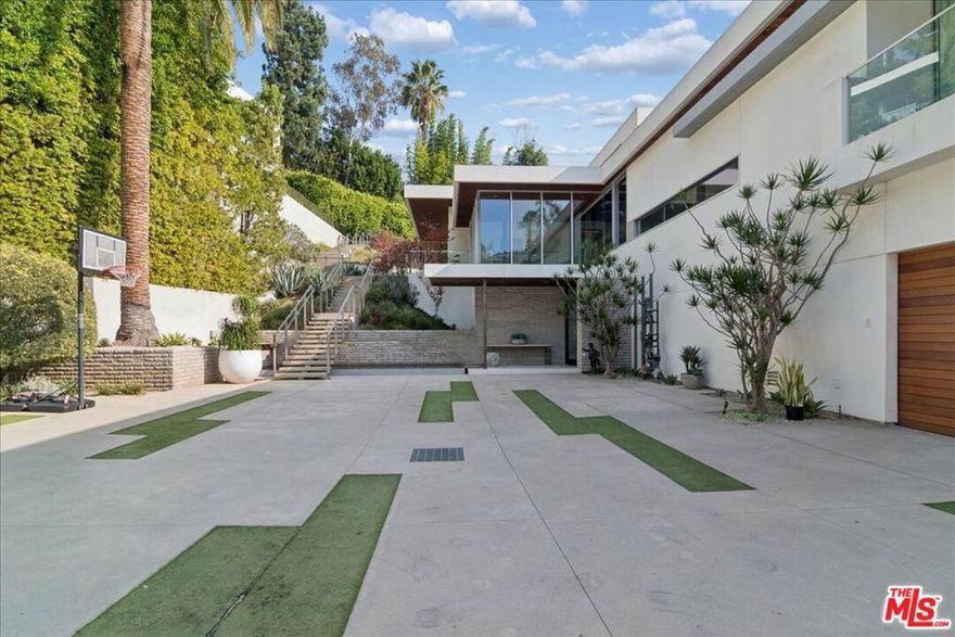 Modern contemporary estate in prime Sunset Plaza with approx. 10,020 sqft of exceptional design and seamless indoor-outdoor living. The main residence features 6 bedrooms, 9 bathrooms, expansive open living spaces, floor-to-ceiling glass, chef's kitchen, formal dining, multiple lounges, a state-of-the-art theater, and full smart-home integration. Walls of glass open to a resort-style pool, and generous outdoor entertaining areas.  A detached 2-story ADU/guest house approx 1,530 sqft offers 2 bedrooms, 2 bathrooms, partial kitchen, dining area, sitting area, and its own city view ideal for guests or staff.  Gated motor court with a 5-car garage plus additional parking for up to 7 vehicles. Above the garage is an additional light-filled space approx 1,560 sqft with its own private half bath perfect for a gym, office, conference room, studio, or creative workspace.  Exceptional privacy and luxury just moments from the Sunset Strip.