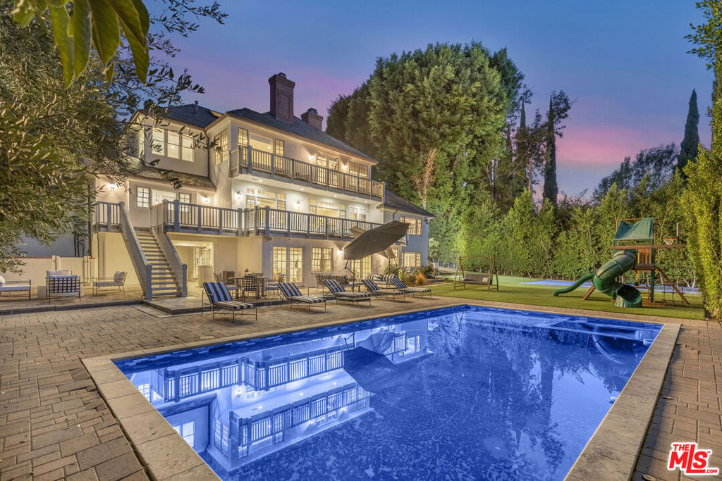 The listed price is for an unfurnished yearly rental. However, the property is also available for shorter-term rentals or as a fully furnished option at an additional premium. When rented furnished, the home comes beautifully decorated and equipped with hotel-quality essentials and amenities, offering a comfortable and convenient living experience. Flexible pricing options are available based on rental terms and furnishings. With our concierge team available to assist 24/7, this home rental offers a five-star hospitality experience, whether you are staying for a few days, a month, or a year. This luxurious 6,000 sq ft estate in Sherman Oaks offers breathtaking panoramic views and exceptional living spaces. With 6 spacious bedrooms, each with a private bath, and a total of 8 bathrooms, it provides ample privacy and comfort. Elegant gathering spaces include a formal living room with a fireplace, a family room, and a formal dining room. The chef's kitchen features high-end stainless steel appliances, including a Wolf 8-burner range and Sub-Zero refrigerator. Additional amenities include a custom home theatre, recreation room, sports court, private pool, and built-in BBQ, all introduced by a grand circular driveway, making this home a perfect blend of luxury and entertainment.
