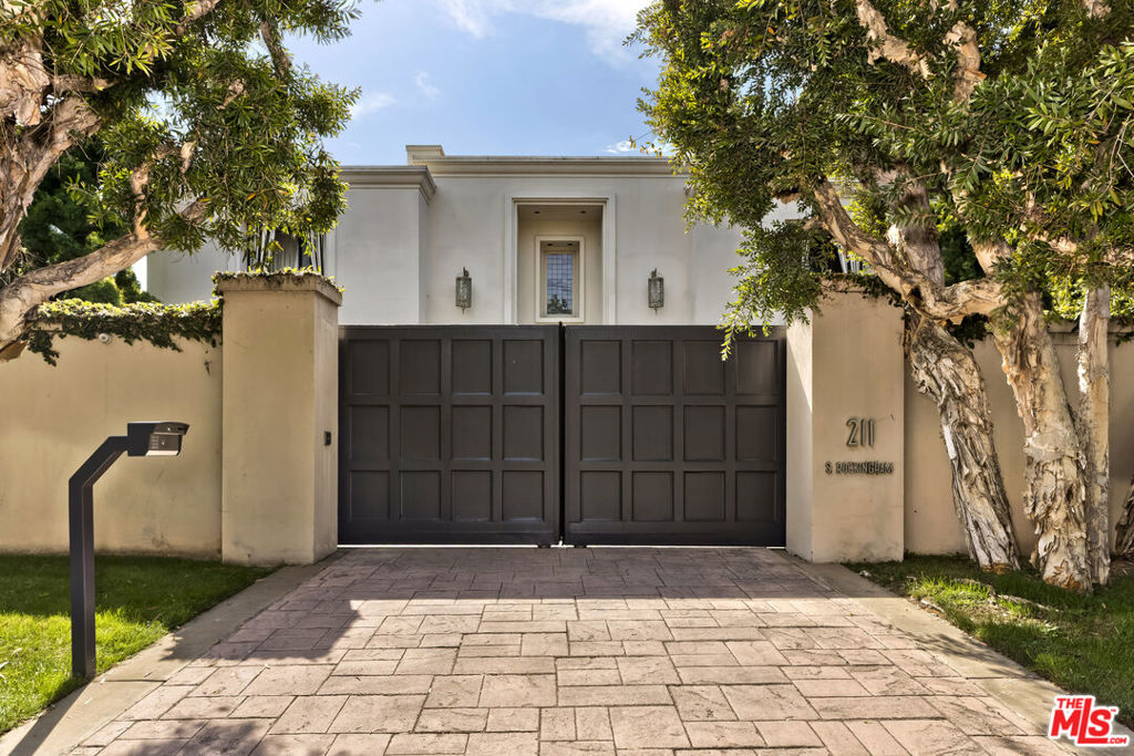 Welcome to an unrivaled, glamorous architectural retreat by Bob Ray Offenhauser, on the rim of Brentwood Park. Tucked behind secure gates, this home is designed for effortless indoor-outdoor living. The timeless design is evident throughout, with expansive windows and fine finishes. Gracious living spaces bathed in natural light create an ideal environment for both entertaining and relaxation. Each piece of furniture has been meticulously crafted to harmonize with the architectural elements of the state. The formal dining room, a cozy family room with a fireplace, and a gourmet chef's kitchen with breakfast area complete the living areas. Upstairs, there is a spacious primary bedroom with dual bathrooms, ample closets, and a sitting room/office attached to it. Each of the two spacious bedrooms features an en-suite bathroom, balcony, and fireplace. The guest bedroom has its separate entrance. Step outside and discover a private oasis featuring a stunning pool, jacuzzi, fireplace, barbecue, panoramic canyon views