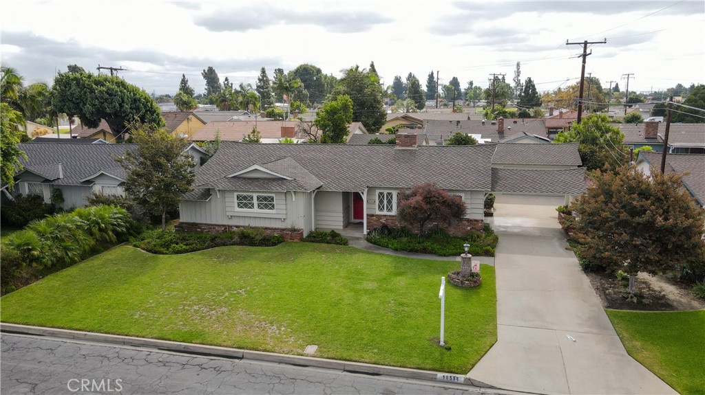 This wonderful Downey home, located on a cul-de-sac, is on the market for the first time in 58 years. It features a large living room with a fireplace and a generously sized den. The dining area is adjacent to the kitchen, which is equipped with a dishwasher and tile countertops. There's also an inside laundry room with a sink and a half bathroom conveniently located between the laundry room and the kitchen.
The master bedroom offers two closets, including a walk-in, and an en-suite three-quarter bathroom with a dressing area, which has also been upgraded. A full bathroom at the end of the hall serves the two additional bedrooms.
Recent upgrades to the home include a presidential composition shingle 50-year roof, a new electrical panel installed in 2024, and other plumbing and electrical improvements, as well as central air conditioning and heating. The property boasts a very long driveway with a carport, and the two-car detached garage has an automatic opener. This home is walking distance to Downey High School, Stonewood mall, Doty middle school and Rio San Gabriel elementary school.
