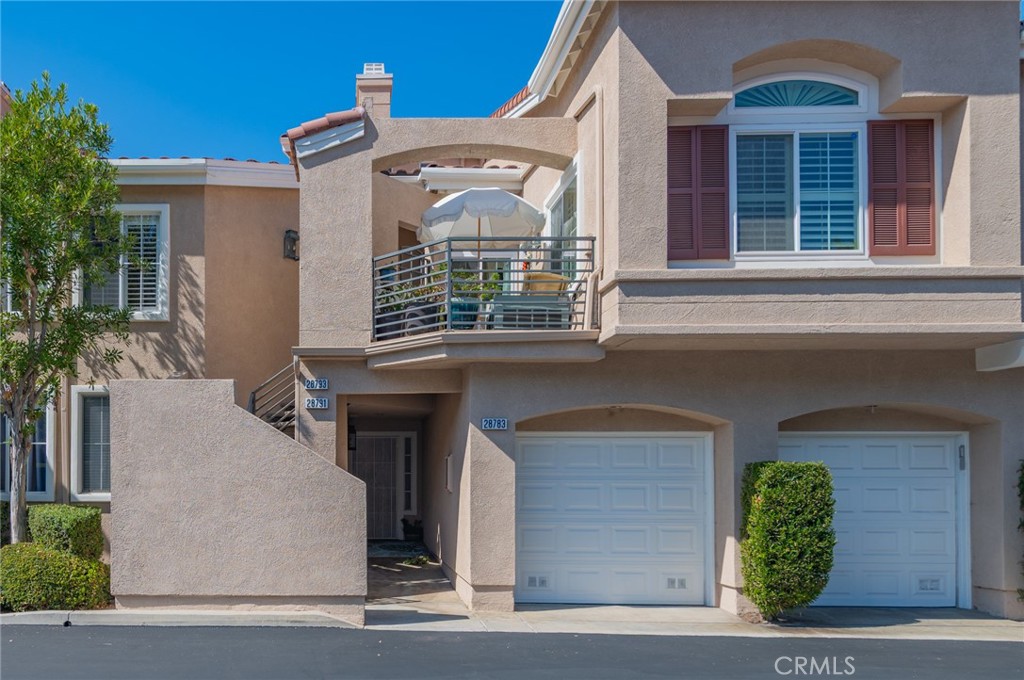 Welcome to this bright and inviting home in the desirable Costa Brava community, offering open space, natural light, and sweeping panoramic views. The spacious living area features vaulted ceilings and connects seamlessly to the dining room and kitchen, creating an easy flow for everyday living and entertaining. The main floor includes a comfortable primary suite with a private bath and ample closet space, plus a secondary bedroom perfect for guests or family. Upstairs, the versatile loft with its own full bath can serve as a third bedroom, office, or flex space. Enjoy the large private balcony ideal for outdoor dining or relaxing while taking in the view. Additional features include an attached one-car garage with direct access, a detached garage, Nest thermostat and sensors, plantation shutters, and ceiling fans. Costa Brava residents enjoy a pool, spa, and playground, with nearby trails around Laguna Niguel Lake and Aliso & Wood Canyons Park. Conveniently located near shopping, dining, beaches, and major freeways, and with optional membership to The Club at Rancho Niguel offering tennis, pickleball, gym, and more—this home combines comfort, function, and the best of South Orange County living.