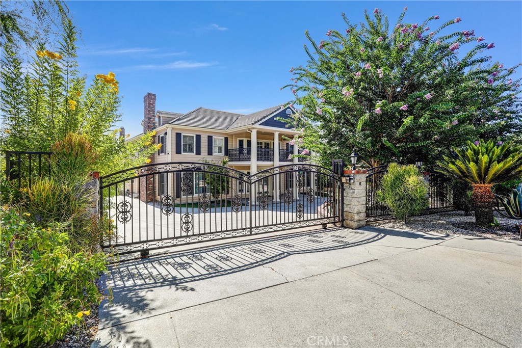 Stunning Gated Estate nestled at the end of a cul-de-sac in prestigious North Arcadia, offers the perfect blend of luxury, privacy, and versatility across a sprawling 38,028 sq. ft. lot. The property features a 6-bedroom, 7,869 sqft traditional-style main house, a 2-bedroom/2-bath guest house with attached garage (858 sqft), a pool house (695 sqft), and a separate fitness center (616 sqft)—making it ideal for multi-generational living or hosting guests.
The main residence welcomes you with a grand double staircase, soaring ceilings, and marble floors. Thoughtful architectural details include multiple fireplaces, custom built-ins throughout, oversized windows for abundant natural light, and solid wood flooring. The gourmet kitchen is a chef’s dream with a large center island, custom cabinetry, and a cozy breakfast nook with direct access to the expansive backyard deck. Formal living and dining rooms offer elegant entertaining spaces, while a state-of-the-art office and home theater add modern functionality.
The luxurious primary suite features a covered balcony with serene views, while additional bedrooms also offer private balcony access. The detached guest house mirrors the quality of the main residence, with high-end finishes, an open floorplan, a full kitchen, and custom closets.
Step outside to your personal resort—complete with a sparkling pool & spa, spacious pool deck, tennis court, golf cage, and beautifully landscaped grounds. With separate structures and ample space, this estate is ideal for extended families or those seeking ultimate privacy and flexibility.
Located minutes from the 210 Freeway and close to hiking trails, shopping, dining, this rare offering combines lifestyle, location, and luxury.