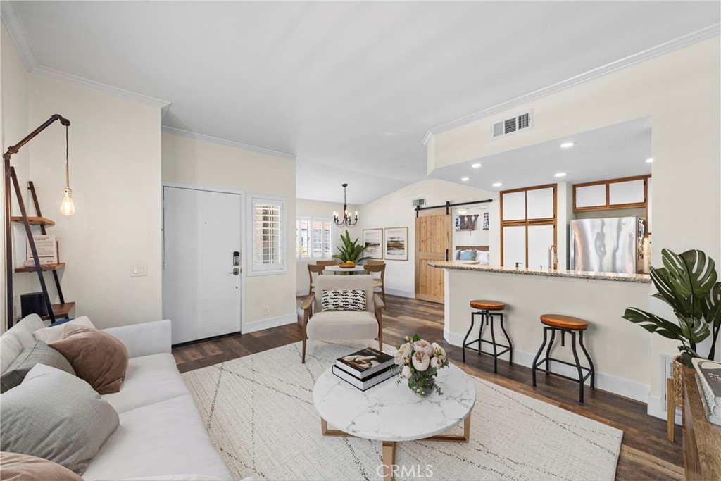 BACK ON MARKET due to buyer inability to perform. Welcome to this beautifully updated, light-filled carriage-style end unit in the desirable Bella Ventana community of Rancho Santa Margarita. With no neighbors above or below, this private and peaceful home features an attached one-car garage directly beneath the unit, plus an additional designated parking space for convenience. The exterior of the community was recently painted giving the neighborhood a fresh modern look that compliments the homes updated interior. Step inside to soaring vaulted ceilings and an airy, open living space bathed in natural light. Thoughtfully updated throughout, the interior boasts fresh paint, newly installed wide-plank luxury vinyl flooring with a warm wood-like finish, new plush carpeting, and new baseboards. The family and dining areas have been virtually staged with furnishings to showcase the home’s functionality and spacious layout. The kitchen blends style and function with granite countertops, a custom tile backsplash, Kohler sink, Whirlpool dishwasher, and Samsung microwave. A high-efficiency Whirlpool washer and dryer set is also included. Additional features include: Crown molding, WiFi thermostat, Ceiling fan, Custom closet organizers in the Oversized Main bedroom, New bathroom vanity and mirror, Custom plantation shutters throughout, a Private gated balcony perfect for morning coffee or evening relaxation and Central HVAC. Located in a tranquil interior section of this pet-friendly community, residents enjoy access to SAMLARC Amenities including scenic walking trails, greenbelts, Rancho Santa Margarita Lake, the Beach Club, 13 parks and picnic, 4 junior Olympic-size pools, tennis courts, and sports fields. With low HOA dues, award-winning schools, convenient shopping and dining, and easy access to the 241 Toll Road, this move-in ready gem offers the perfect blend of comfort, style, and community + low tax rate and no Mello-roos.