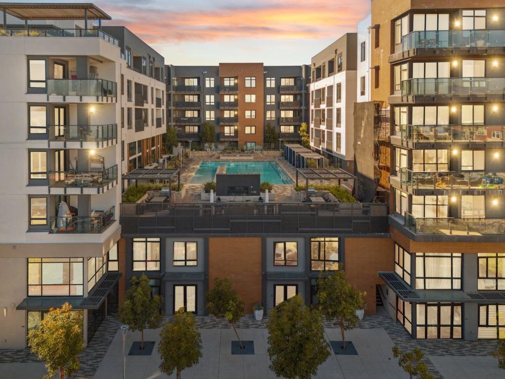 Welcome to this Exquisite 1-bedroom, 1.5-bathroom home offering 1,792 sq. ft. living in the vibrant Silicon Valley with Experience of resort style luxury living in this stunning 2 story condo. As you step inside, you're greeted by natural light through expansive windows & high ceilings. The open-concept layout seamlessly blends the living, dining, and gourmet kitchen areas, high-end stainless-steel appliances, quartz countertops, a spacious island. The well-appointed chef's delight kitchen. The home is enhanced with quartz countertops throughout, hardwood floors, window shades & shutters .A versatile loft area for a second bedroom or creative space. Street level access the unit is zoned for 25% commercial use personal service or office (check with City of Santa Clara). You have access to the main lobby on the 1st level, on the 2nd level, bike storage and pet grooming, a spa and huge swimming pool, community room with flat-screen TVs, a kitchen, pool table, a rooftop deck with BBQs, on the 3rd level, a gym on the 3rd and 4th levels, and a roof top terrace on the 7th level. There is 1 parking space in the gated garage. This prime Santa Clara location places you near top hi-tech companies - Invidia, Google and Apple Don't miss your chance to call Rambla Place Home!