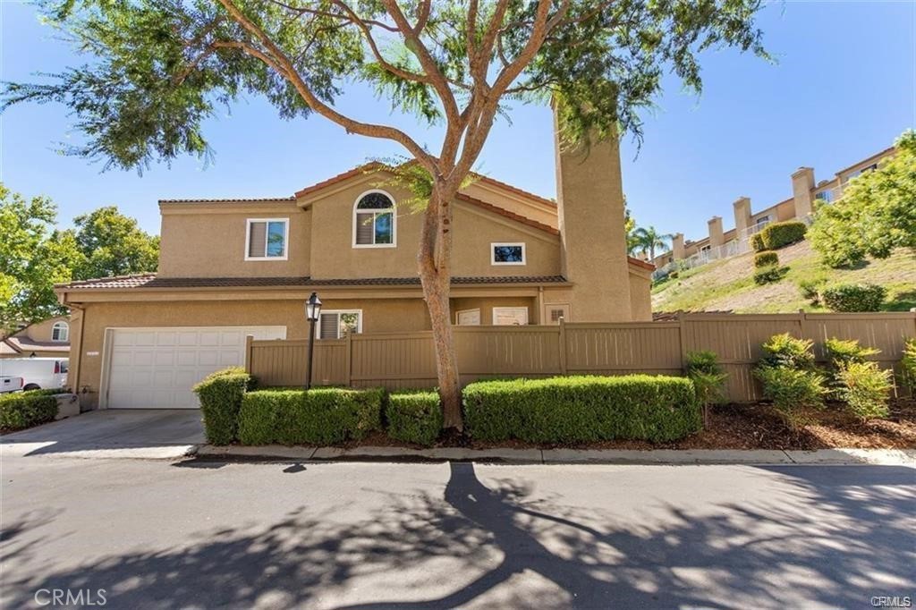 Located just minutes from Crossroads Marketplace, this sought-after end unit offers 3 bedrooms, 3 bathrooms, and a spacious loft. The open-concept living and dining areas flow seamlessly into the kitchen, creating a bright and inviting space. A downstairs bedroom with a ¾ bath across the hall is perfect for guests. Upstairs, the primary suite features a private balcony, dual mirrored closets, and an en-suite bathroom with double sinks, a soaking tub, and separate shower. The third bedroom also includes its own private full bath. The airy loft overlooks the living room and adds extra versatility. Enjoy the private patio for entertaining and a 2-car garage with direct access. Conveniently close to Costco, 99 Ranch Market, 85°C Bakery, Lowe’s, banks, parks, and top-rated schools. Easy access to freeways 71, 60, 10, 210 & 91. Schedule a tour today!