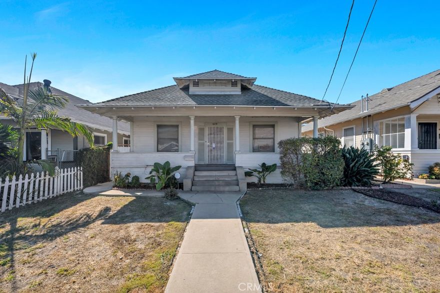 This quintessential 1911 Craftsman-style bungalow captures the spirit of early 20th-century architecture with its timeless design and inviting character. Featuring 2 bedrooms, 1.5 baths, and approximately 1,260 sq ft of living space, this home sits in a desirable San Pedro neighborhood known for its historic charm and convenient location. Original details, like wood siding, statement window casements and door jambs, decorative picture rails, and a stained-glass front door, evoke the warmth of its era, while thoughtful updates provide a comfortable blend of old and new. A covered front porch sets the tone for relaxed coastal living.  The entryway offers period hardwood floors that flow throughout. The cozy living room features a brick fireplace, built-in storage, and a convenient passthrough to the kitchen. The updated eat-in kitchen showcases quartz counters, white shaker cabinets, wainscotting, and ample space for informal dining. Just off the kitchen, a utility room with laundry hookups and a half bath adds function and flexibility. Both bedrooms are generously sized with walk-in closets and share an updated Jack & Jill bath complete with quartz counters, tile flooring, and a classic tile surround. Out back, enjoy a spacious brick patio with a covered area ideal for entertaining or relaxing in privacy. A detached two-car garage with alley access offers parking and storage, or the potential to convert into a private ADU. This rare early-20th century gem offers the opportunity to embrace San Pedro’s historic character while customizing it to suit modern living, close to the harbor, freeways, and the exciting West Harbor waterfront development, with its future mix of dining, retail, and entertainment. A true blend of charm, potential, and location.  Don’t miss out!